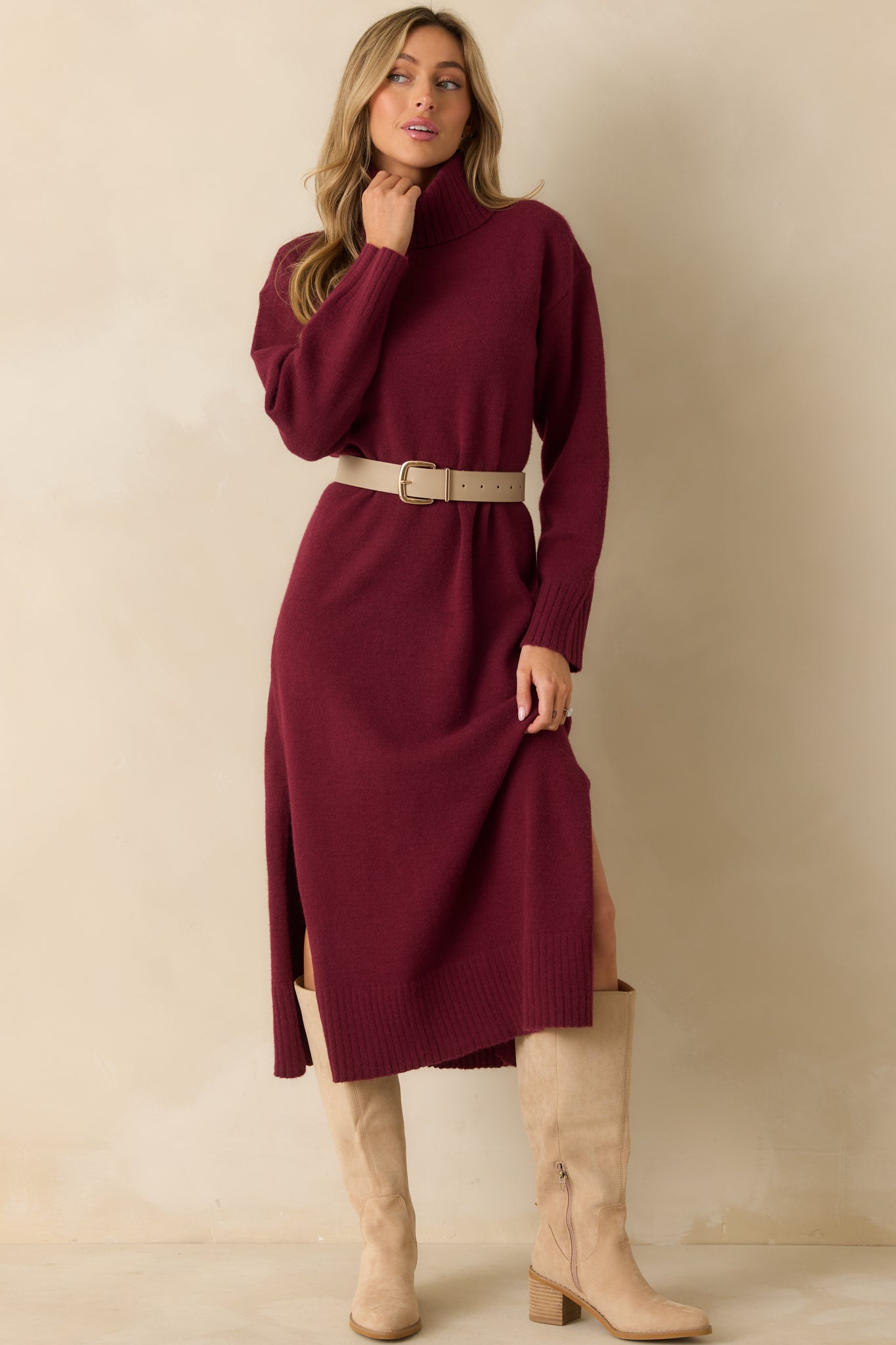 Front view of the burgundy knit sweater dress highlighting the turtleneck, long sleeves, and midi-length silhouette.