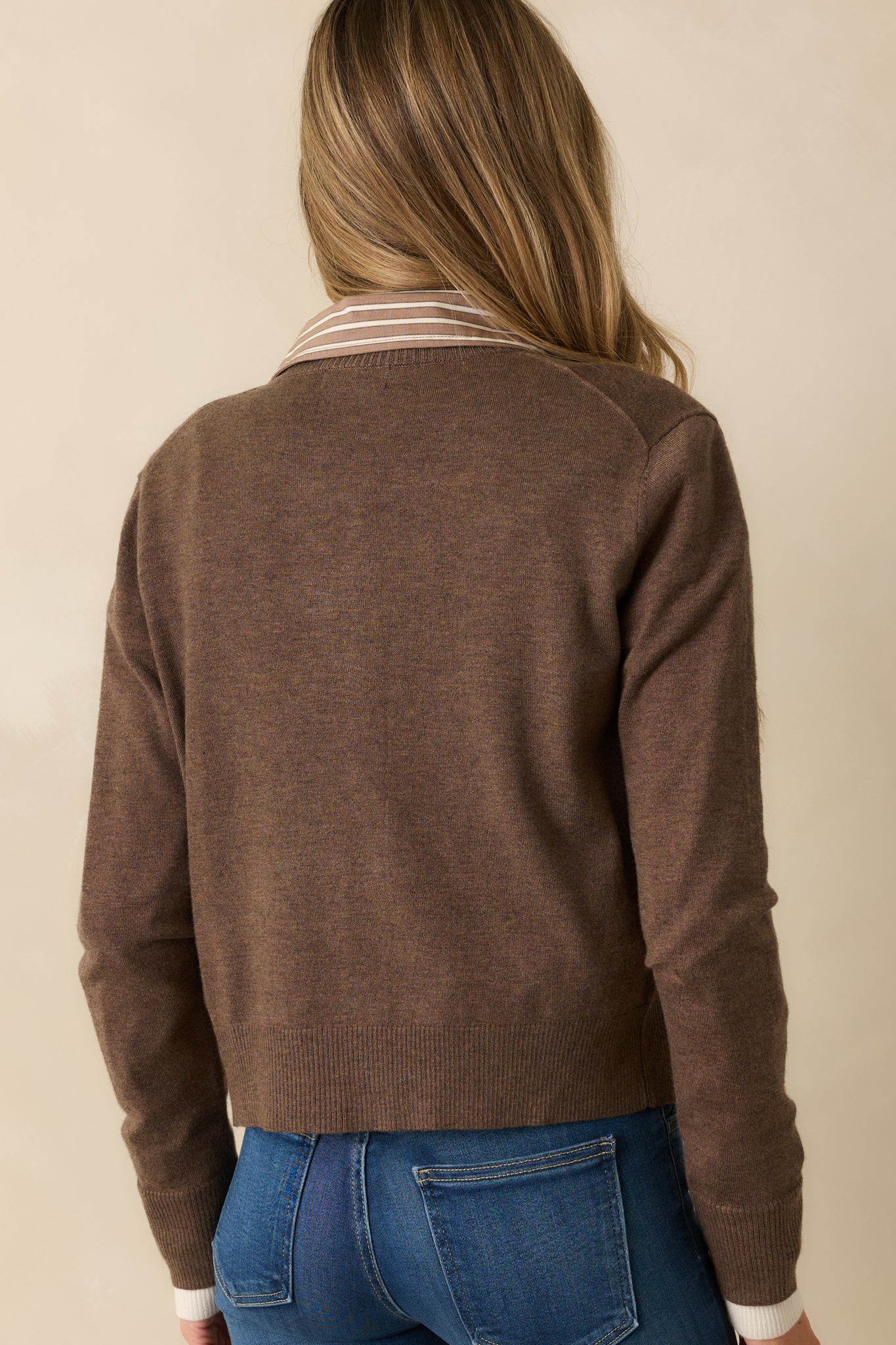 Rear view of the brown cardigan showing the lightweight wool-blend fabric and ribbed hem.