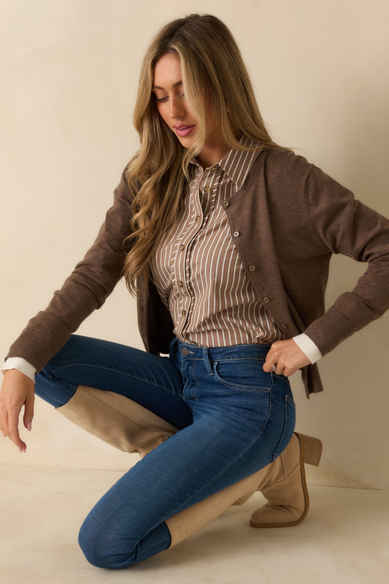 Brown cardigan highlighting the functional button front and smooth knit fabric.