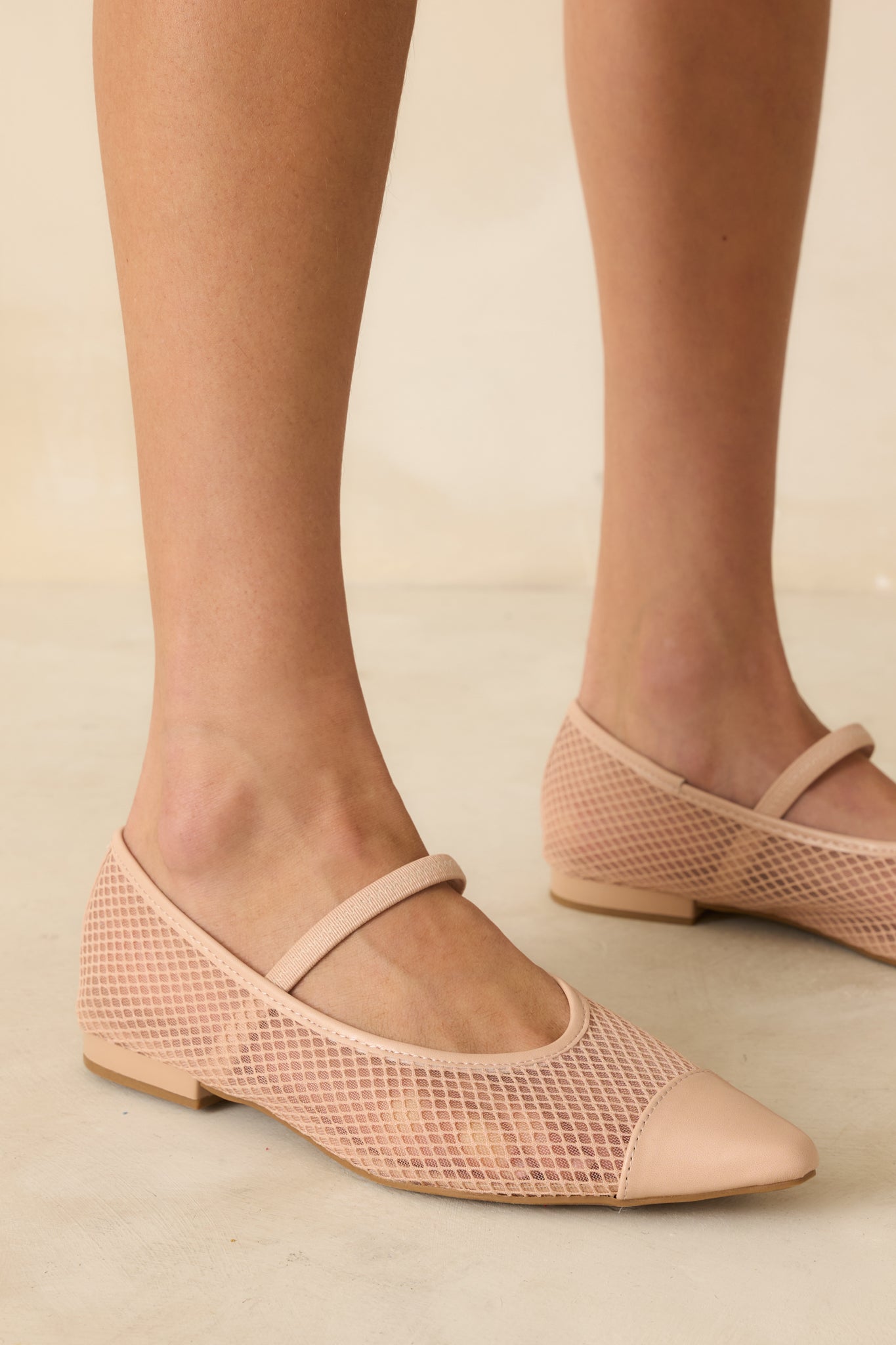 Detail of side mesh and beige trim on flats, emphasizing breathable design and pointed silhouette.
