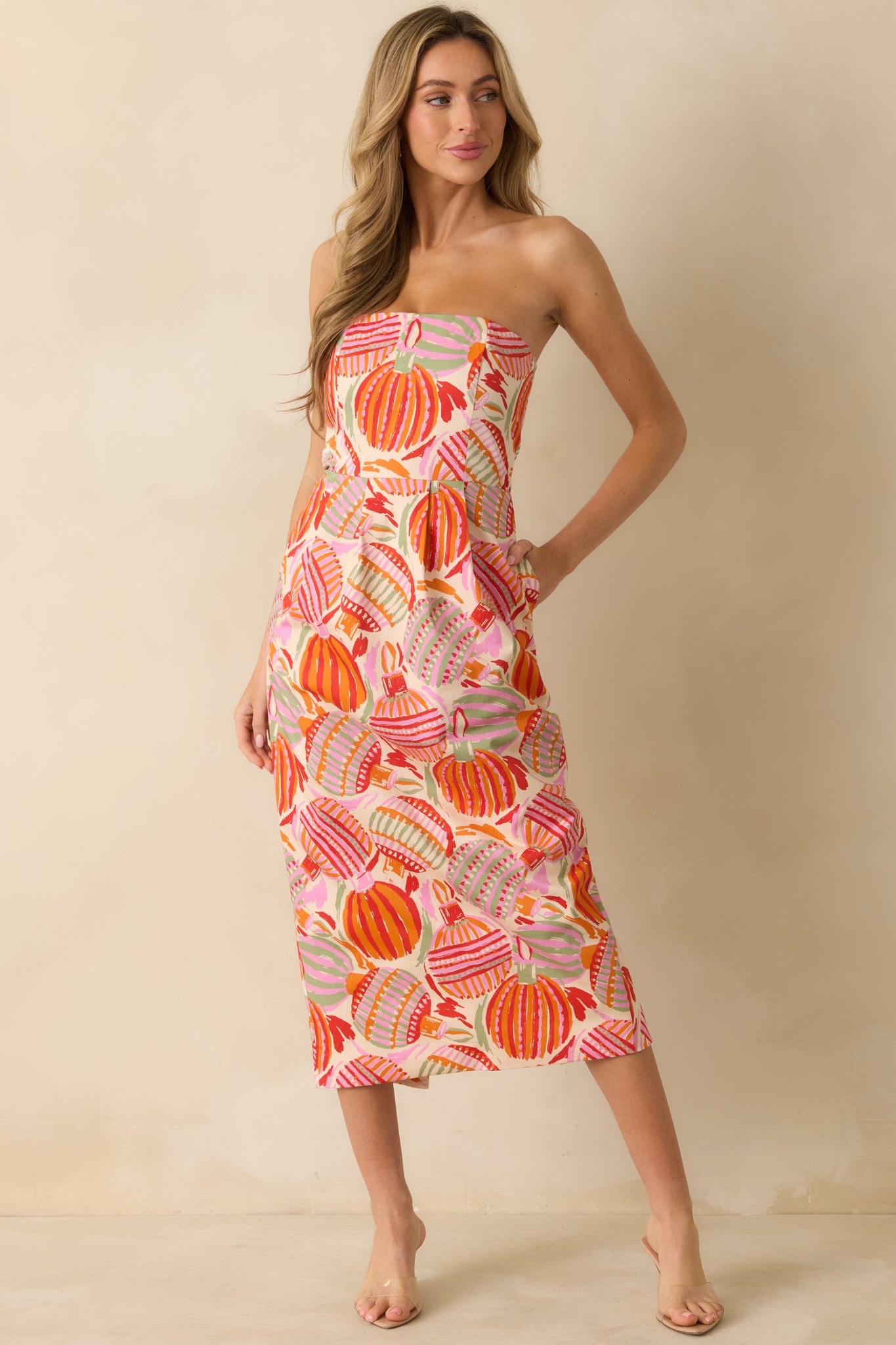 The cotton-blend dress showcases its lively print and tailored shape, balanced by the dramatic bow at the front.