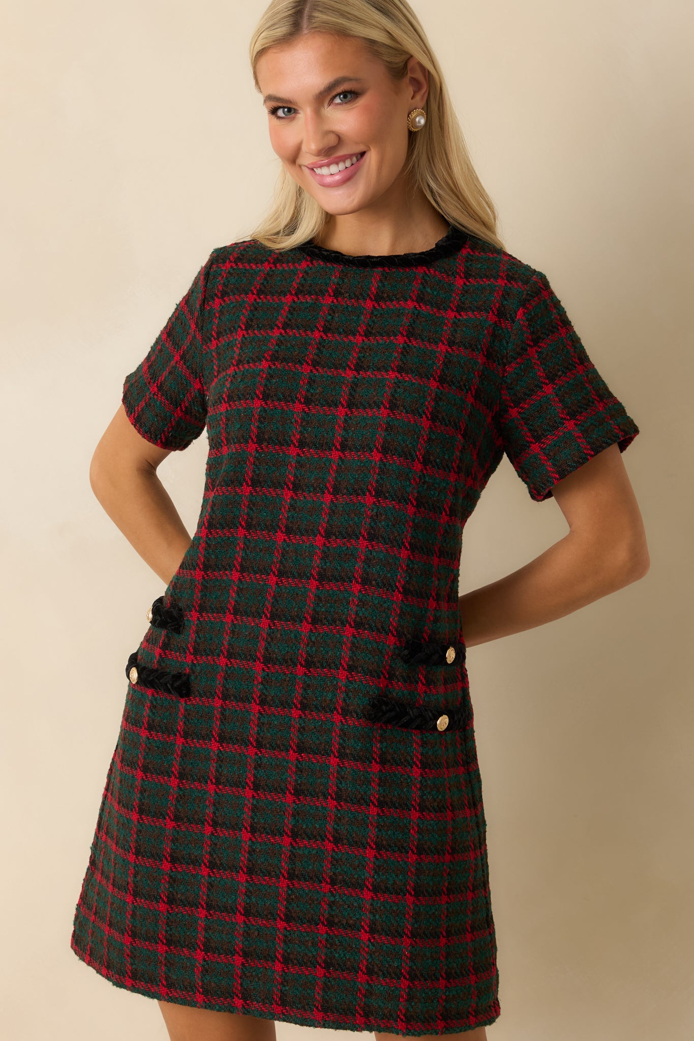 Focus on the crew neckline and short sleeves, showing the dress’s refined tweed texture and clean finishing.