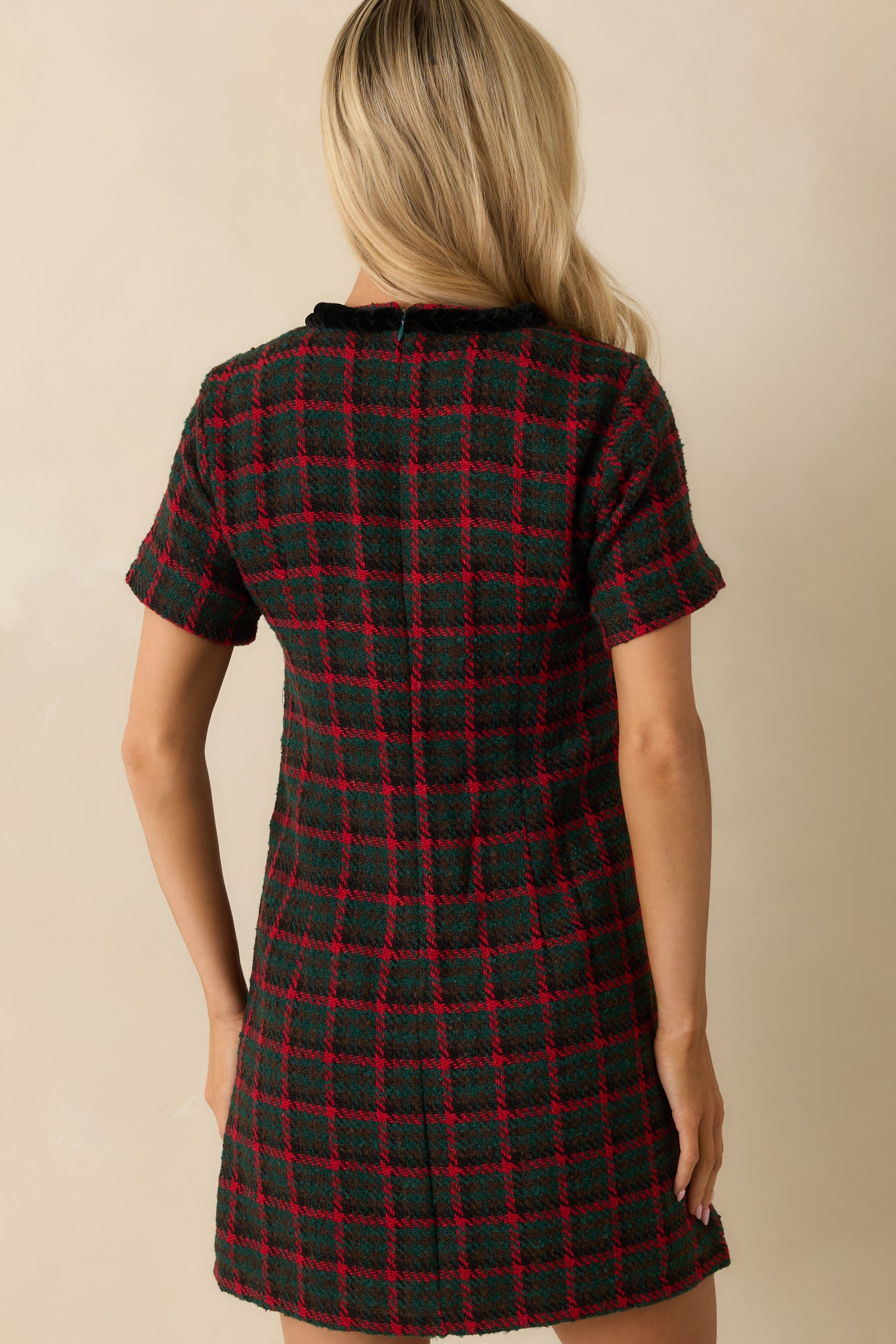 Rear view of the green and red plaid tweed shift dress featuring its smooth lining and streamlined zipper closure.