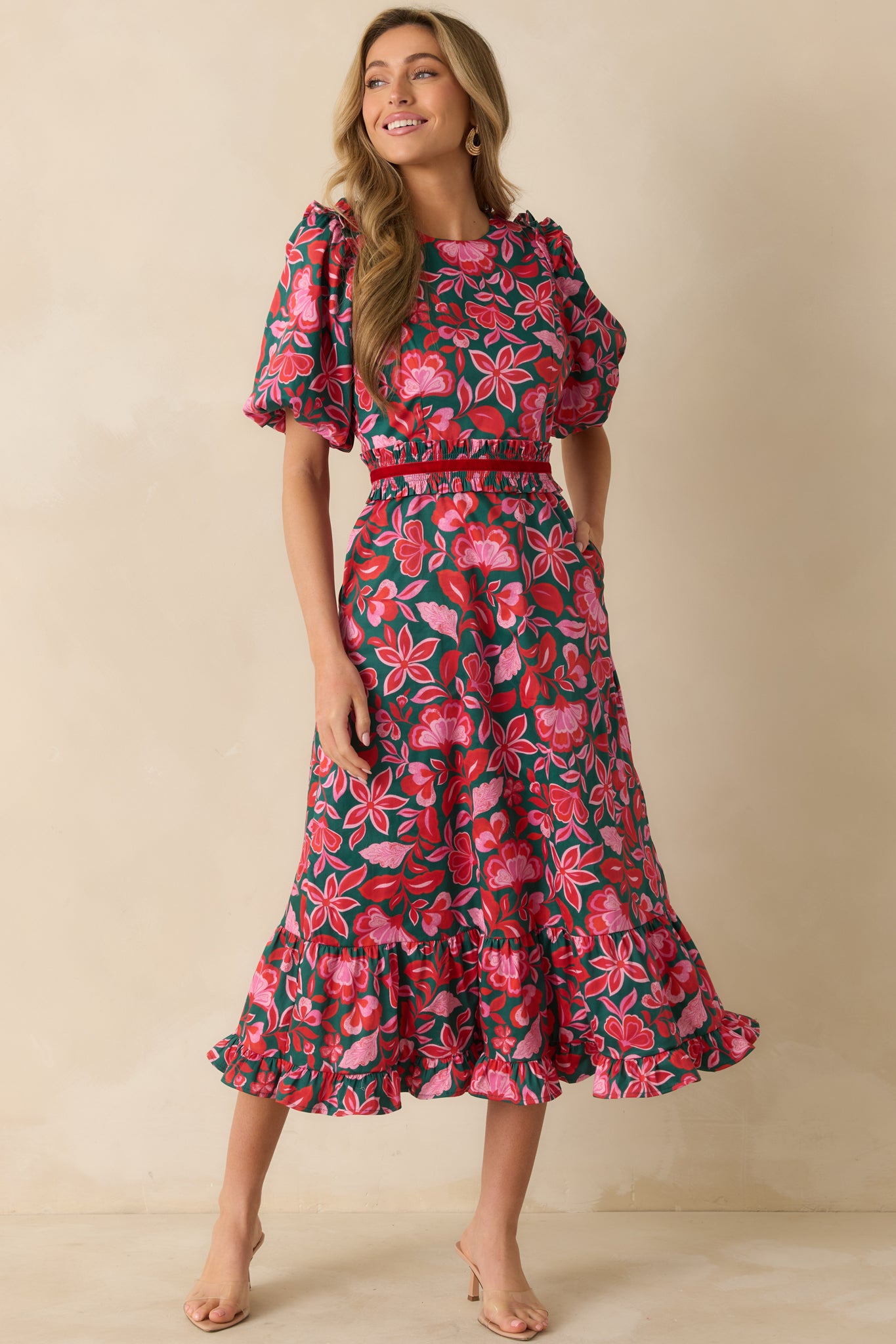 The dress highlights its tiered ruffle hem and full-length silhouette made from crisp cotton.