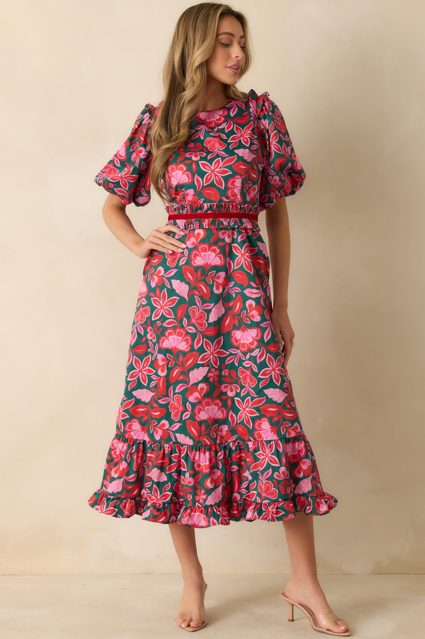 The fitted waist and puff sleeves emphasize the flowing shape and polished cotton fabric.