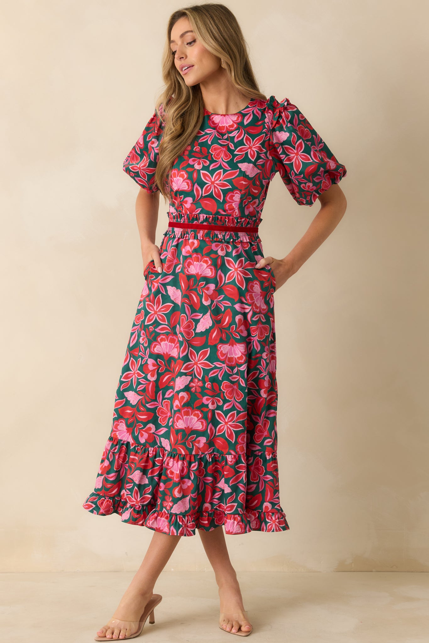 The floral print and tiered hemline create a structured yet airy maxi silhouette.