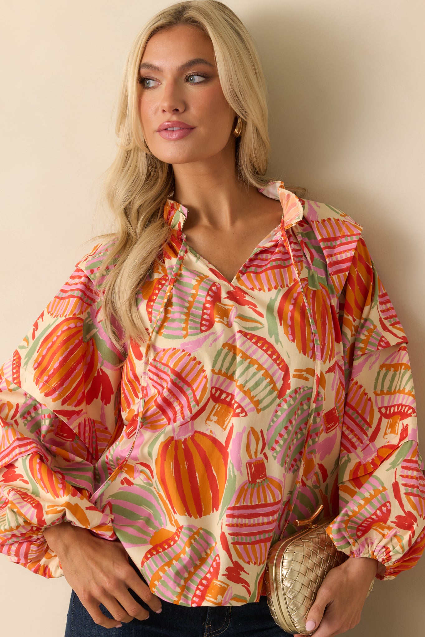 The puff sleeve design is shown with gathered volume and elastic cuffs accenting the colorful print.