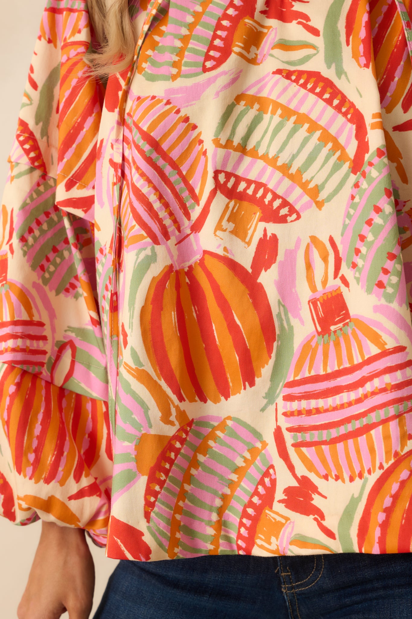 A detailed view reveals the rich ornament print, soft woven texture, and gathered sleeve construction.