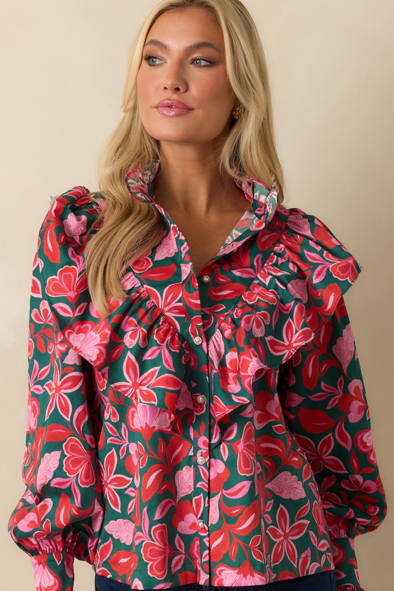 The cropped view highlights the intricate ruffles and delicate green and pink floral motifs.