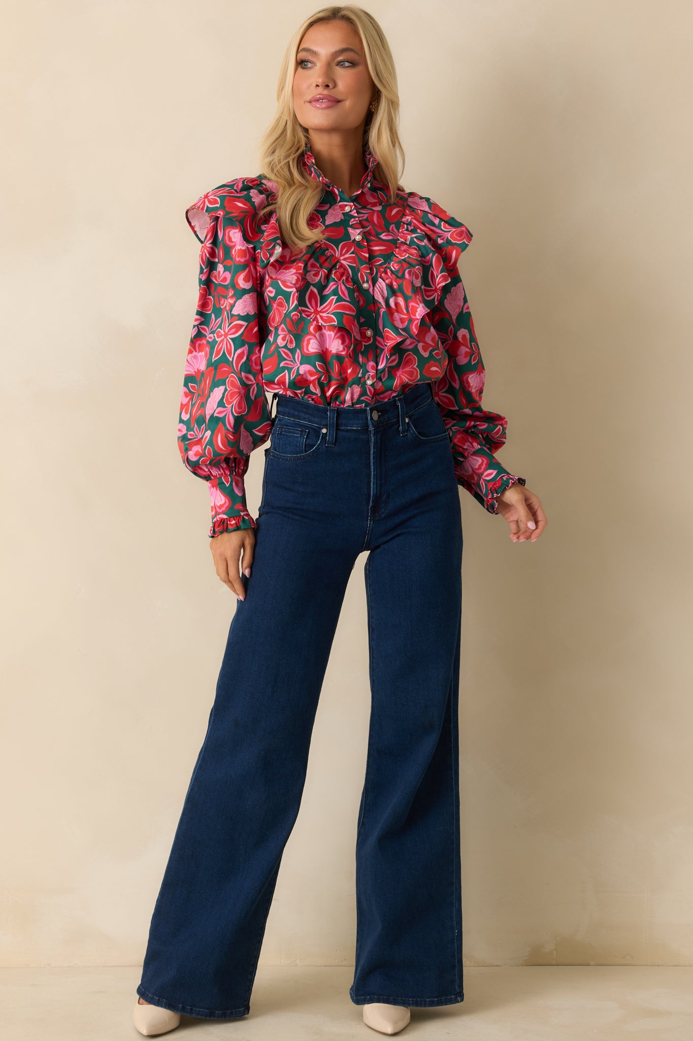 The top displays its green and pink floral print with a button-front design and layered ruffle detailing.