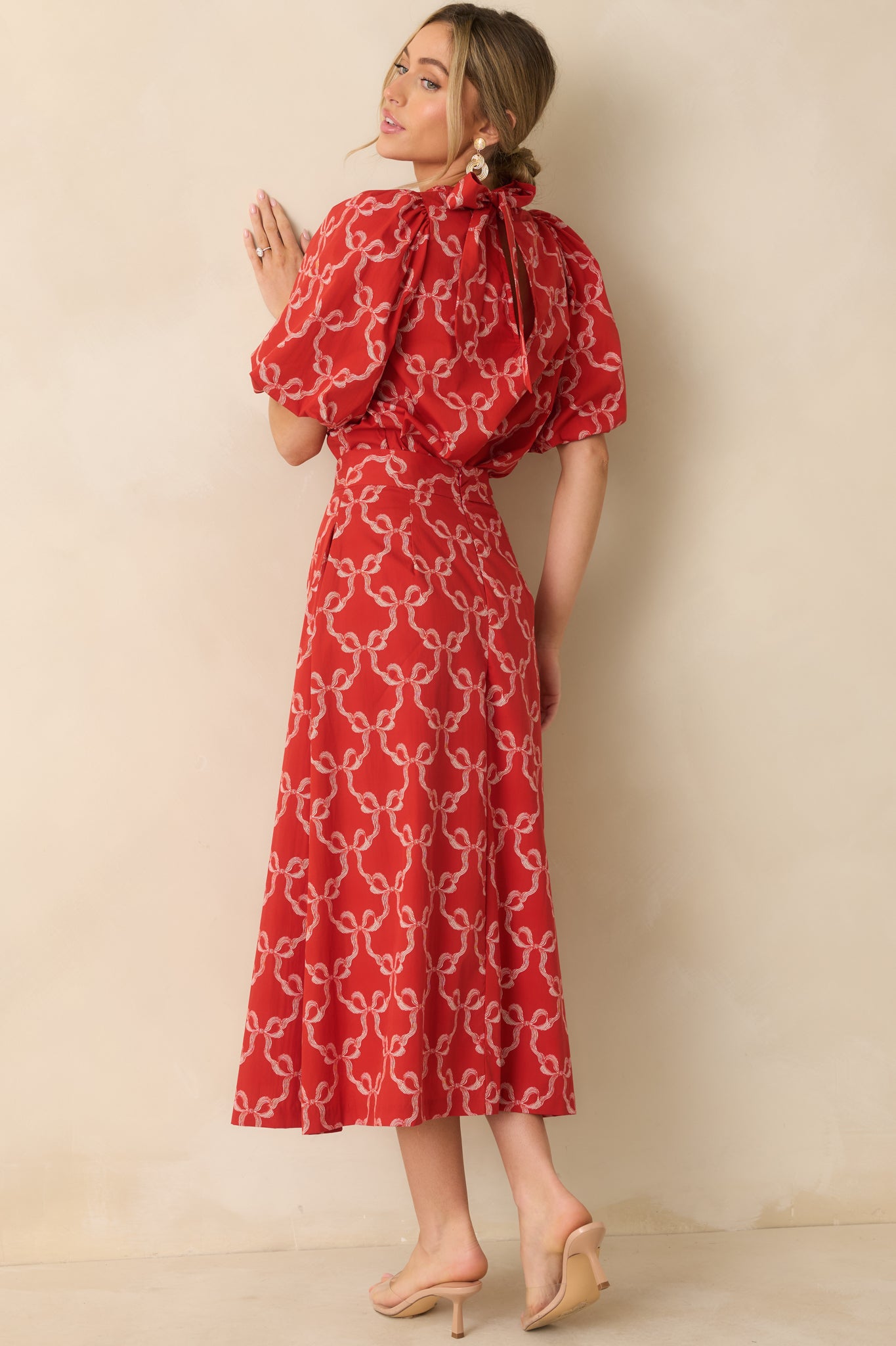 The blouse displays its crisp woven cotton and gathered neckline paired with gentle sleeve volume.