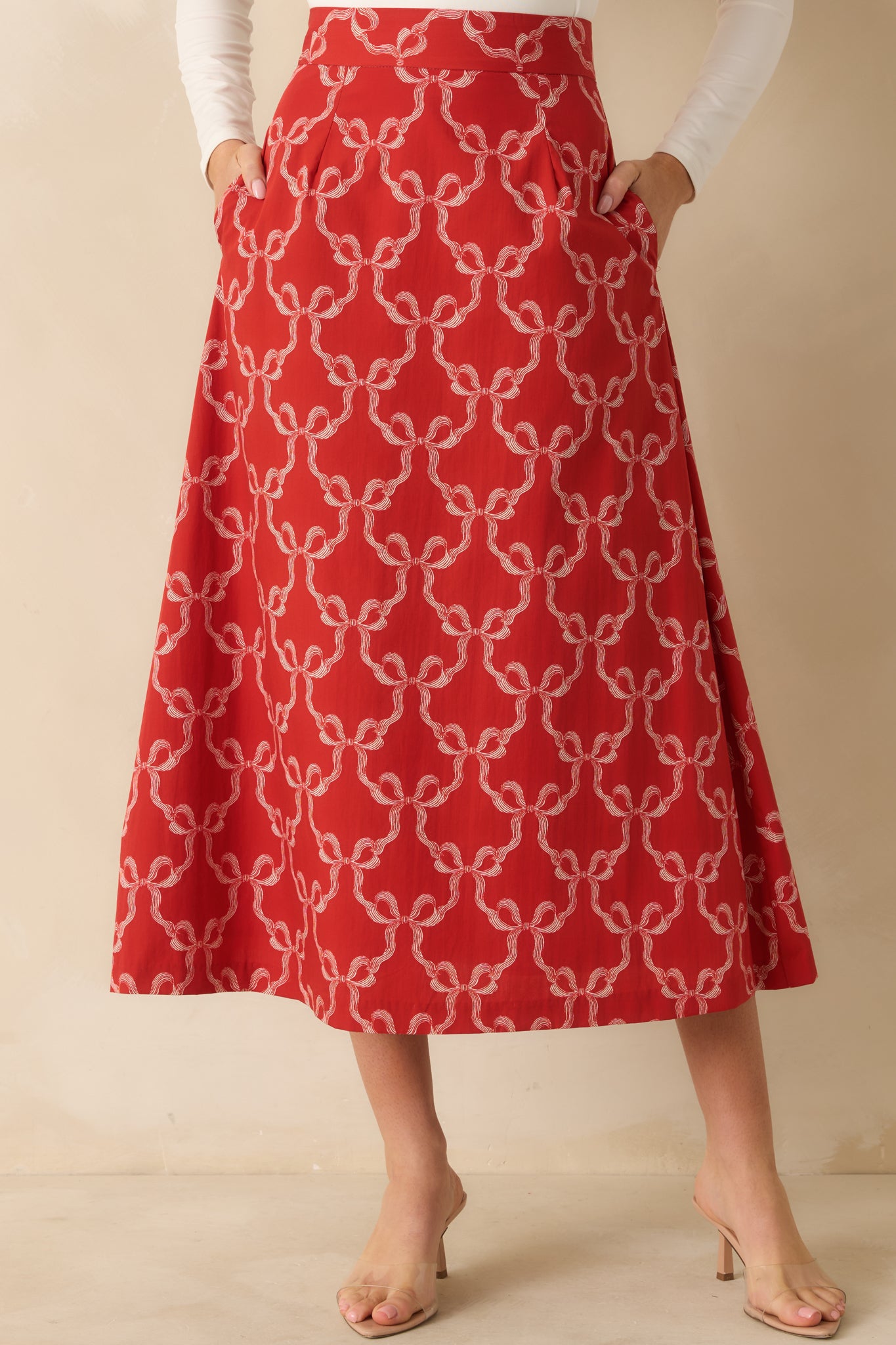 The A-line shape and playful bow print appear clearly across the midsection and upper skirt.