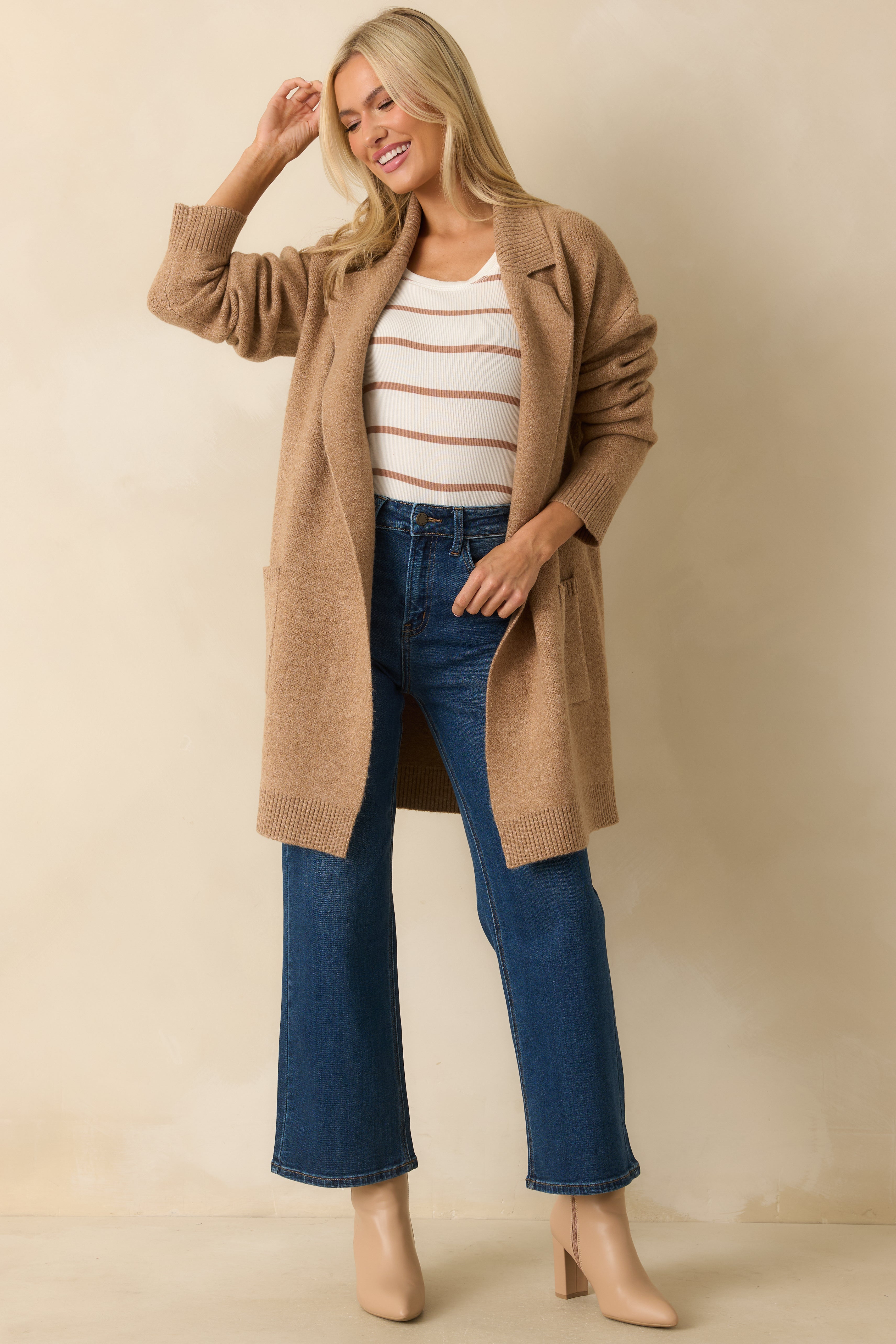 Classic camel knit cardigan styled with an open front and functional patch pockets