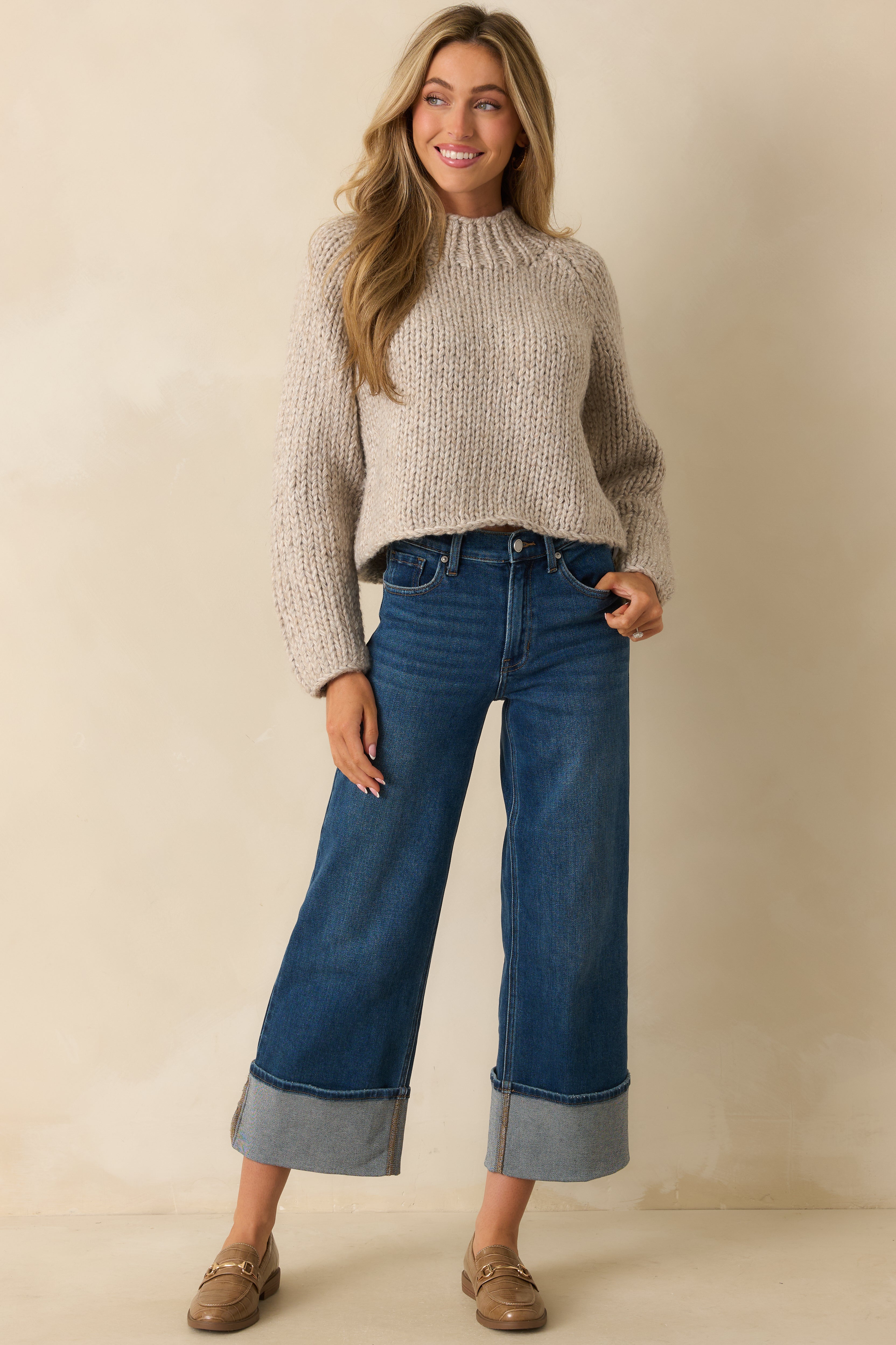 Front-facing view highlighting the long sleeves and textured thick yarn throughout the cropped silhouette.