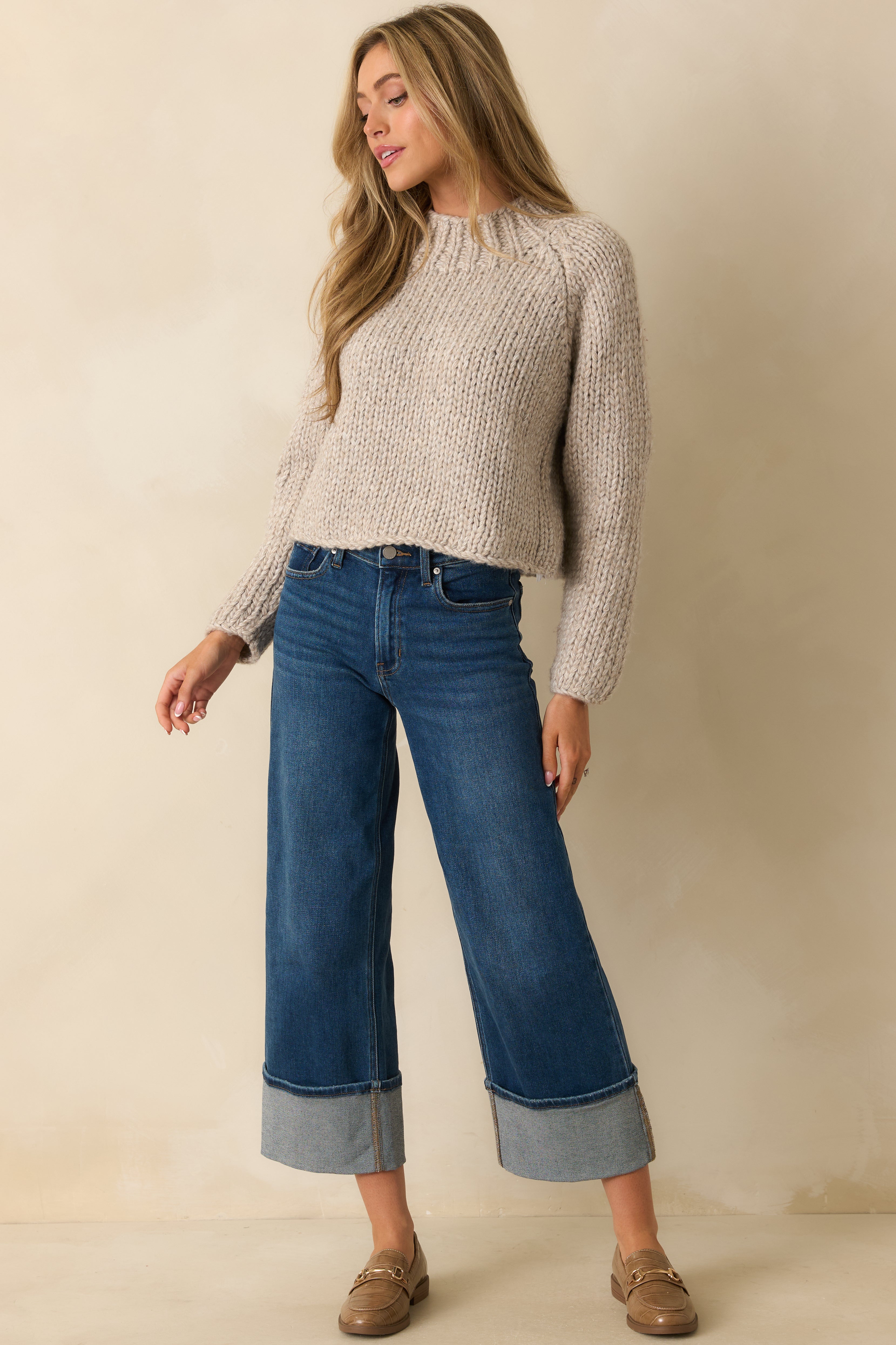 Front view of the oat-colored chunky knit cropped sweater showing the ribbed mock neckline and relaxed fit.
