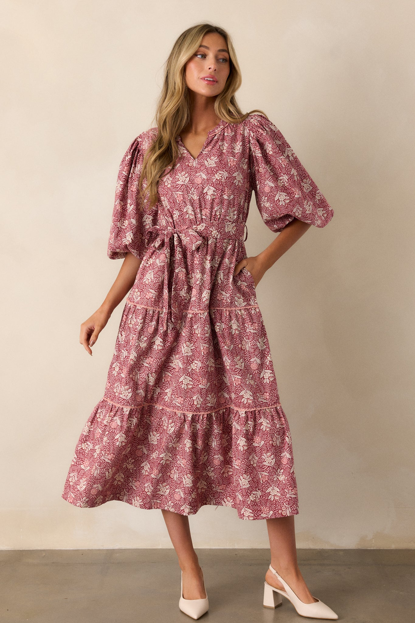 Full-length view from an angle, capturing the playful puff sleeves and the tiered design of the skirt as it cascades down.