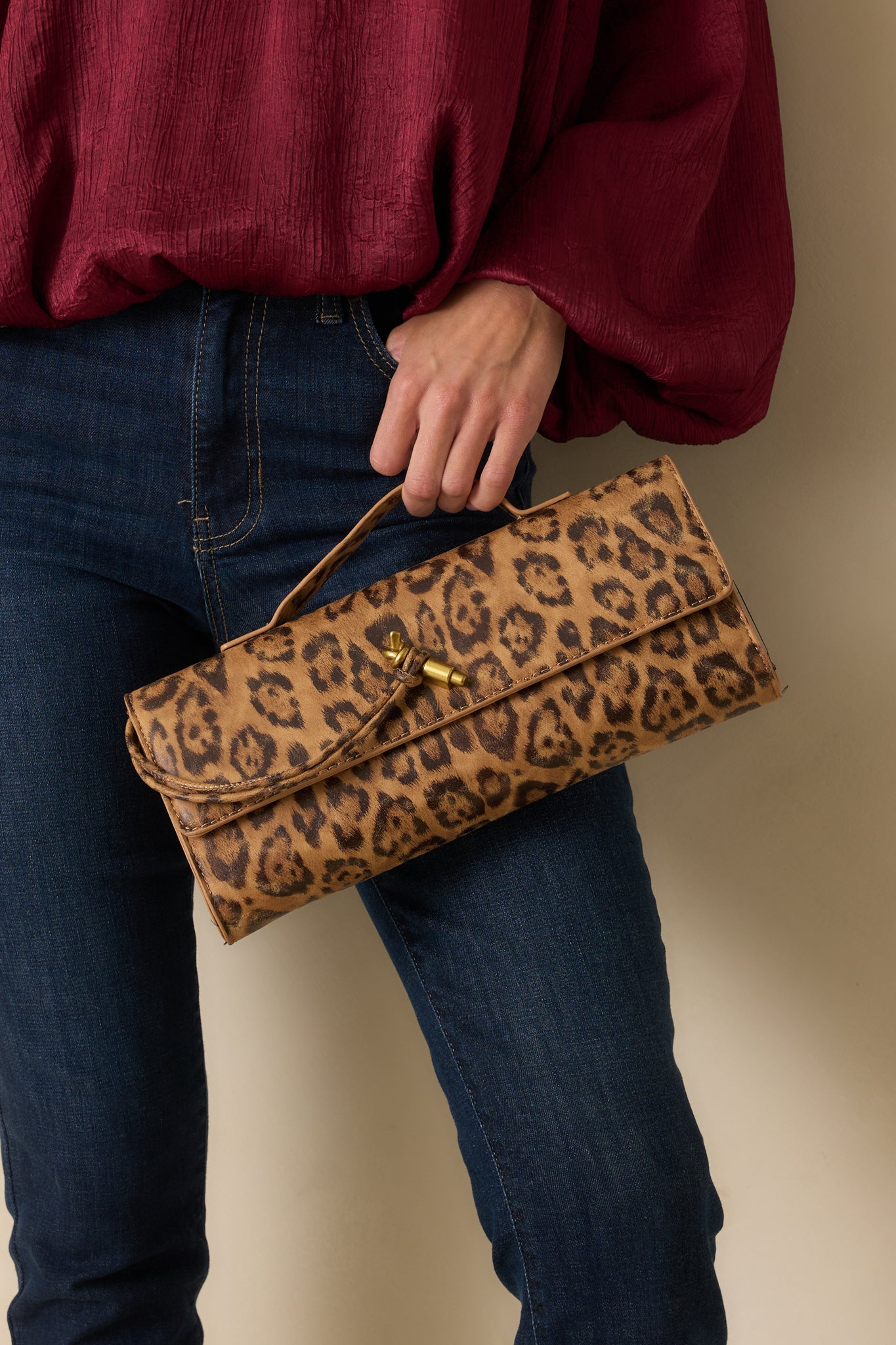 Leopard print clutch displayed from the front, highlighting its bold animal pattern and magnetic flap closure.