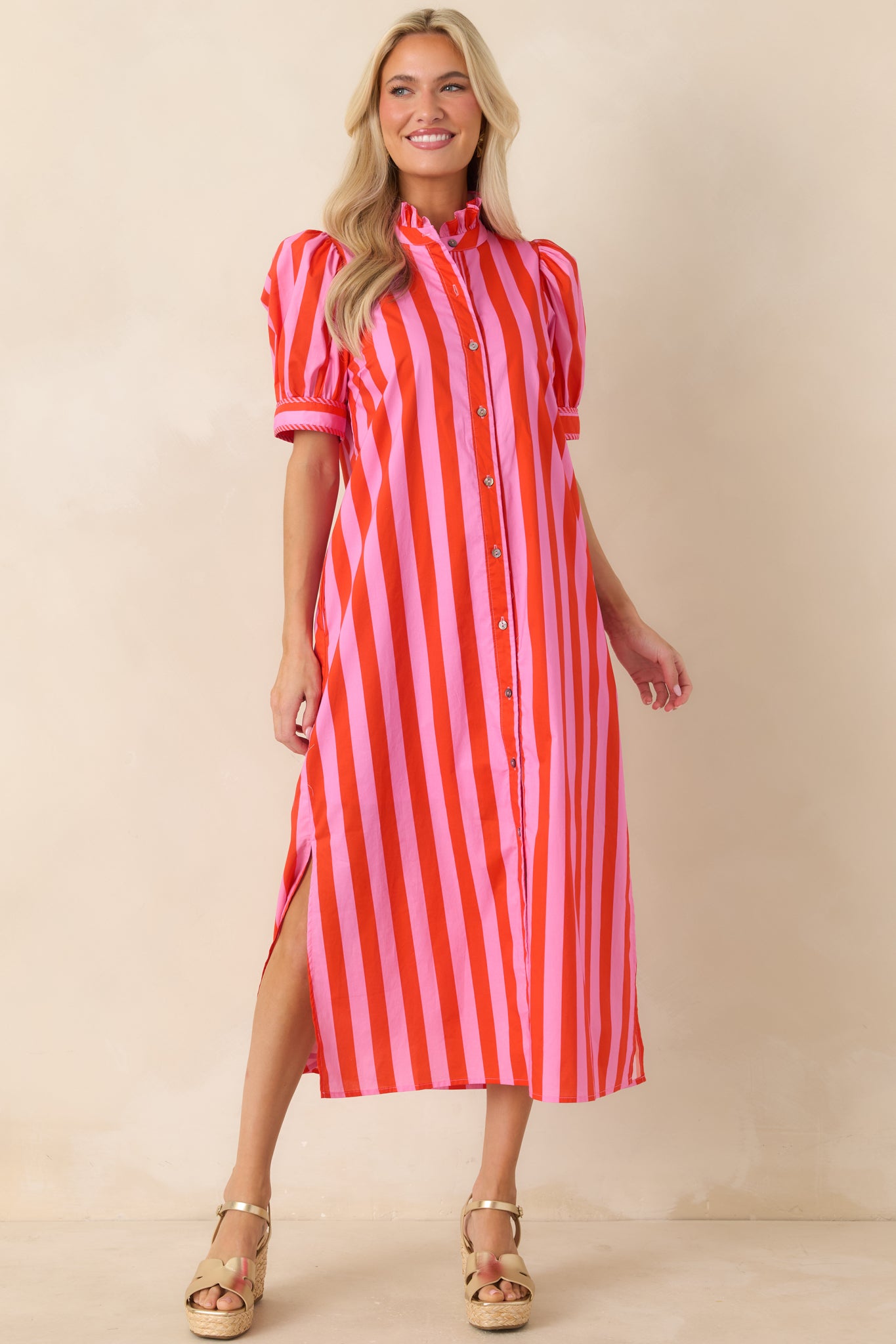 Lightweight cotton midi dress with vertical stripe pattern and a relaxed yet structured warm-weather silhouette.