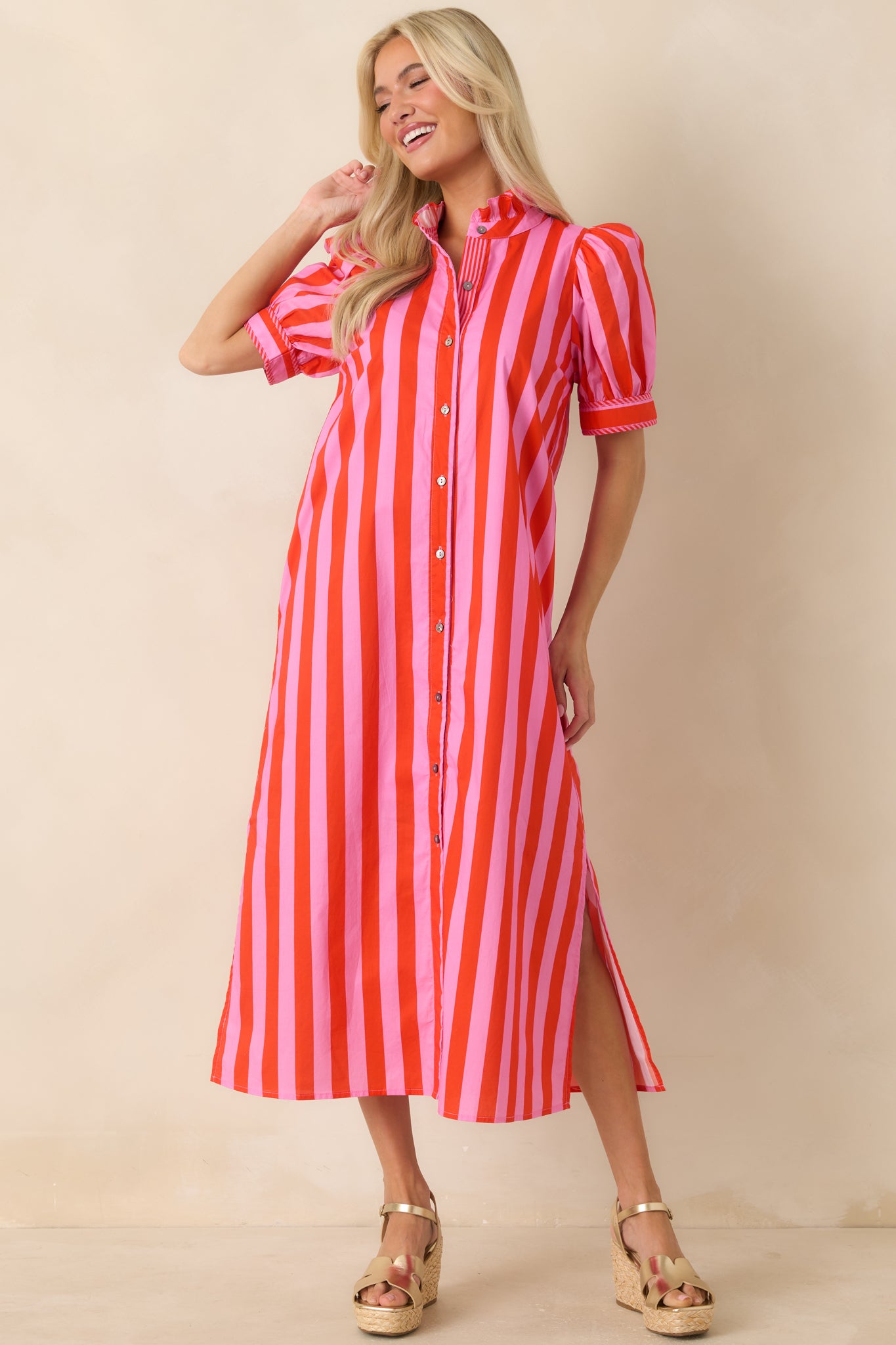 Pink striped midi dress showcasing puff sleeves and full button-front detail in breathable 100% cotton fabric.