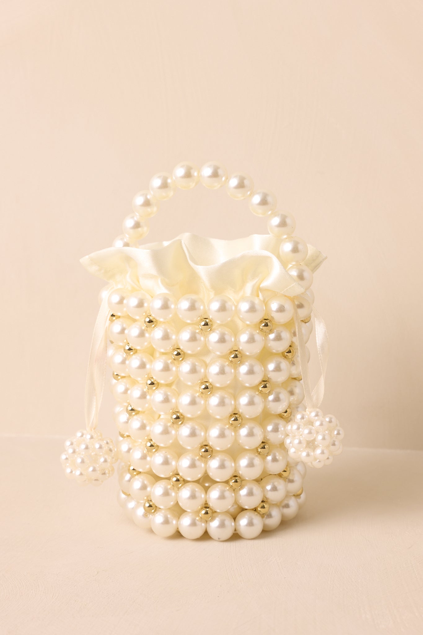 Close-up of the removable ivory satin lining and interior craftsmanship of the pearl clutch.