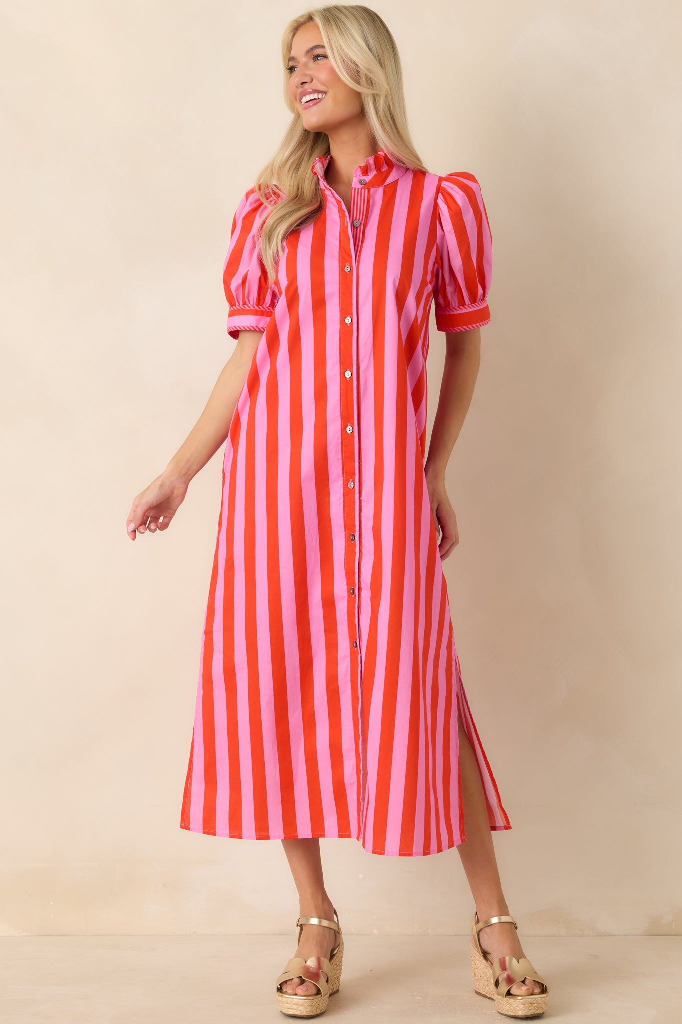 Red and pink striped dress with midi length, functional pockets, and soft puff sleeve design.