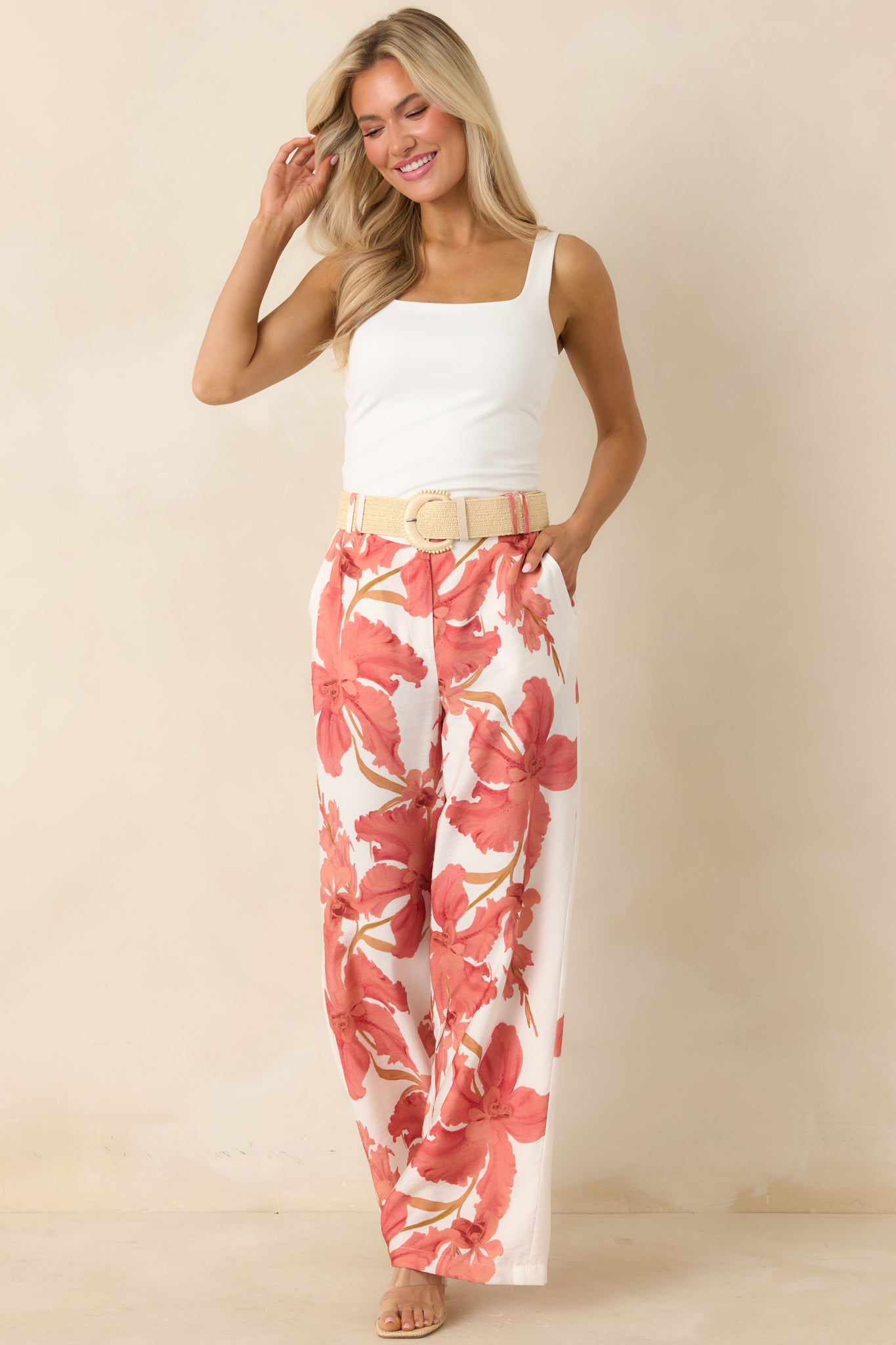 Hibiscus print pants with a breezy wide leg silhouette and soft peach tones for a polished yet relaxed look.