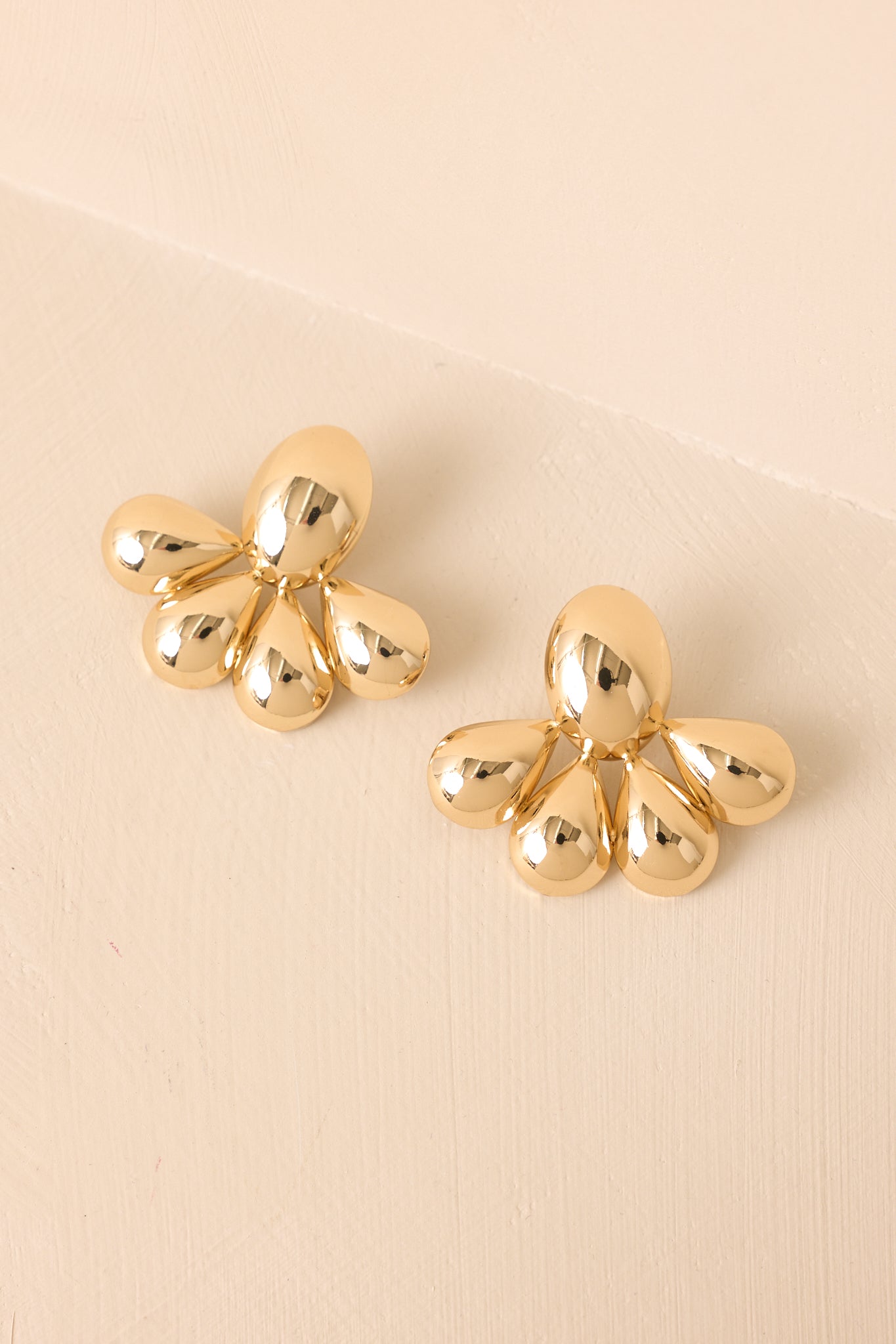 Angled shot showing the earrings from a slight tilt, focusing on the shape and symmetry of the teardrop elements.