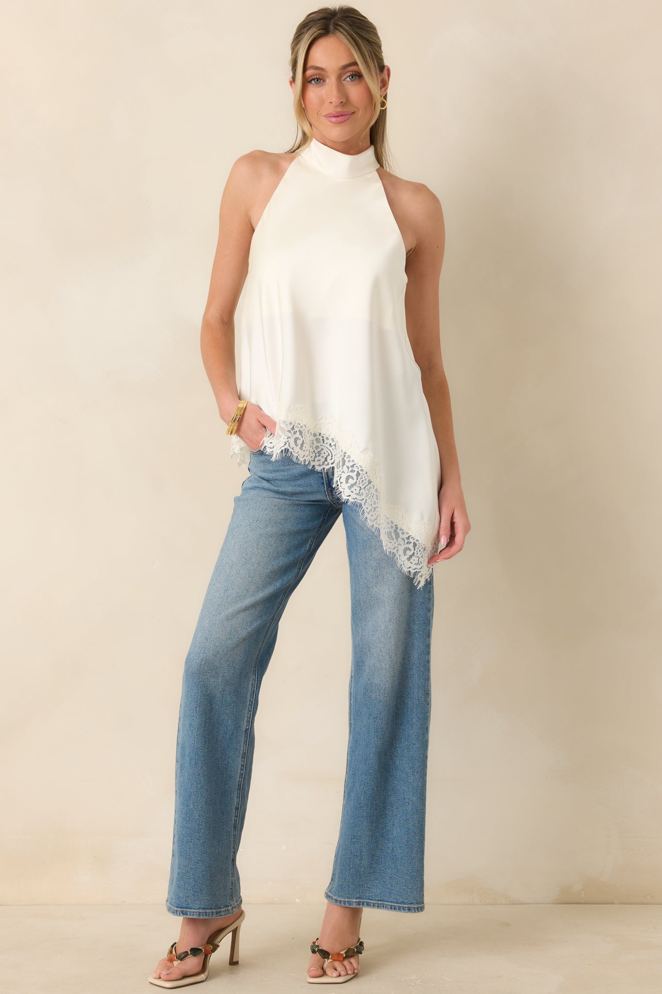 Chic ivory halter top with intricate eyelash lace detailing and a relaxed silhouette designed for elevated everyday styling.
