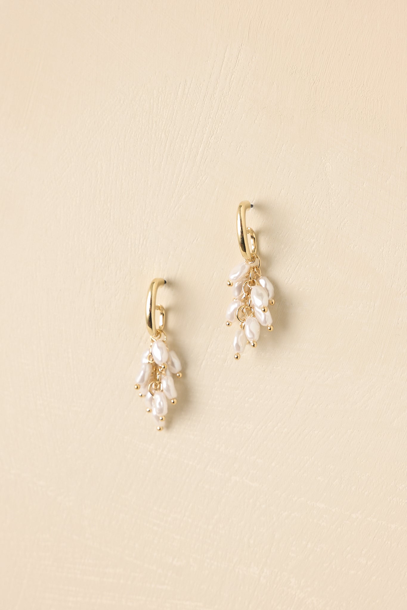 Pearlescent, clustered drop earrings with gold hardware.