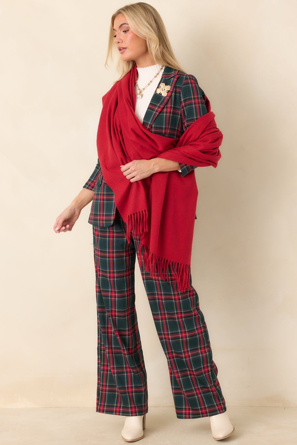 Model wearing dark green wide-leg pants with a red and white tartan plaid pattern and full-length hems