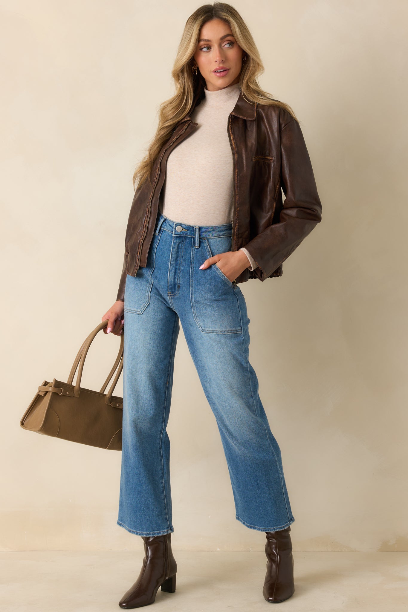 Brown jacket displaying the welt chest pocket and flexible fit through the hem.