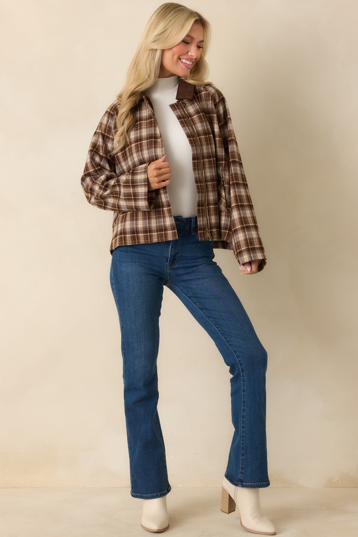 Brown jacket displaying functional side pockets and smooth front finish.