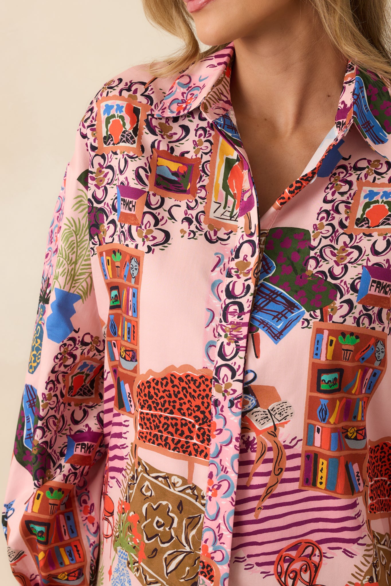 A detailed view shows the pointed collar, button cuff, and woven fabric with the full salon-inspired print.