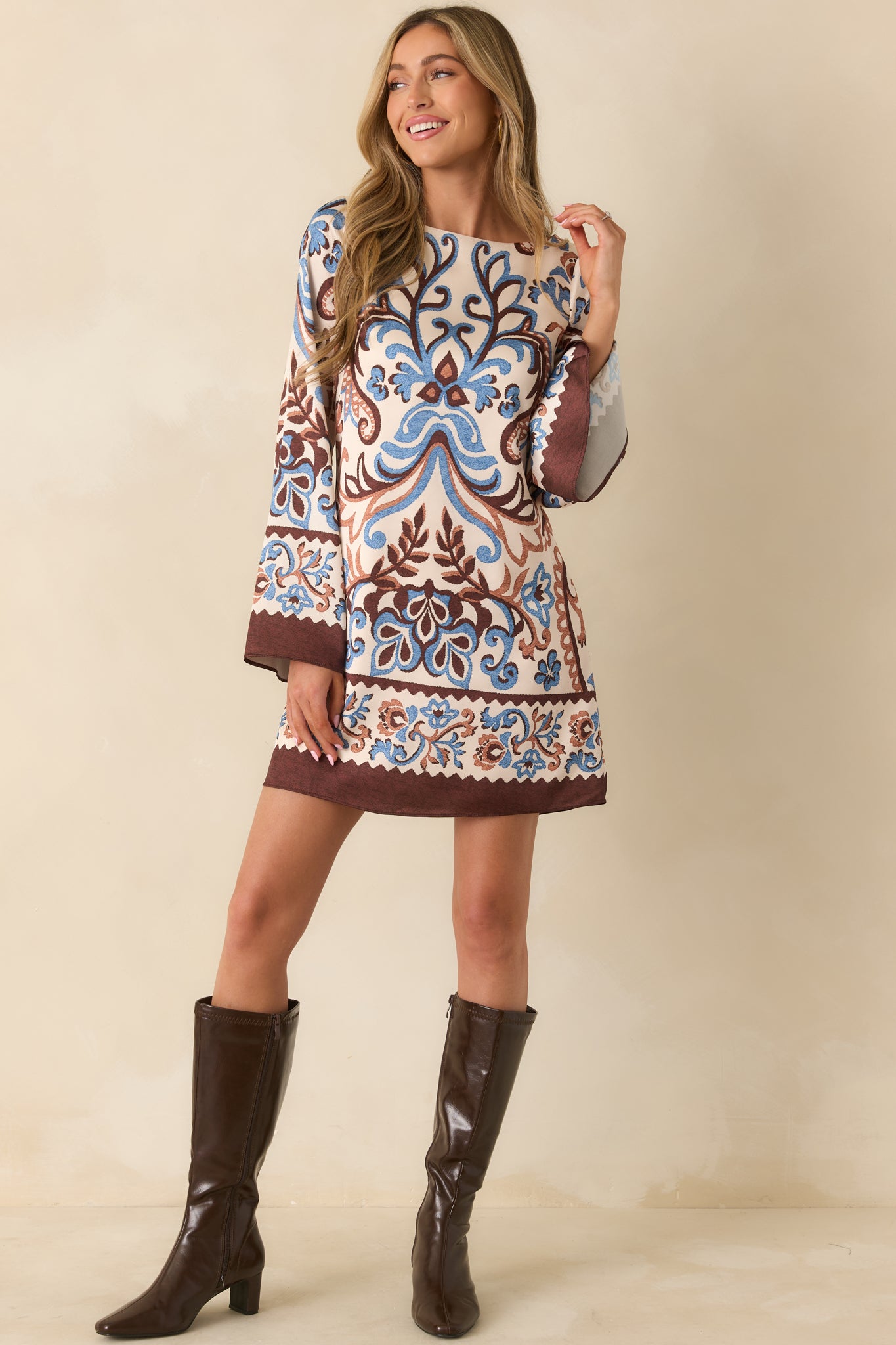 Full view highlighting the dress’s mini length, paisley pattern, and relaxed fit through the torso and sleeves.