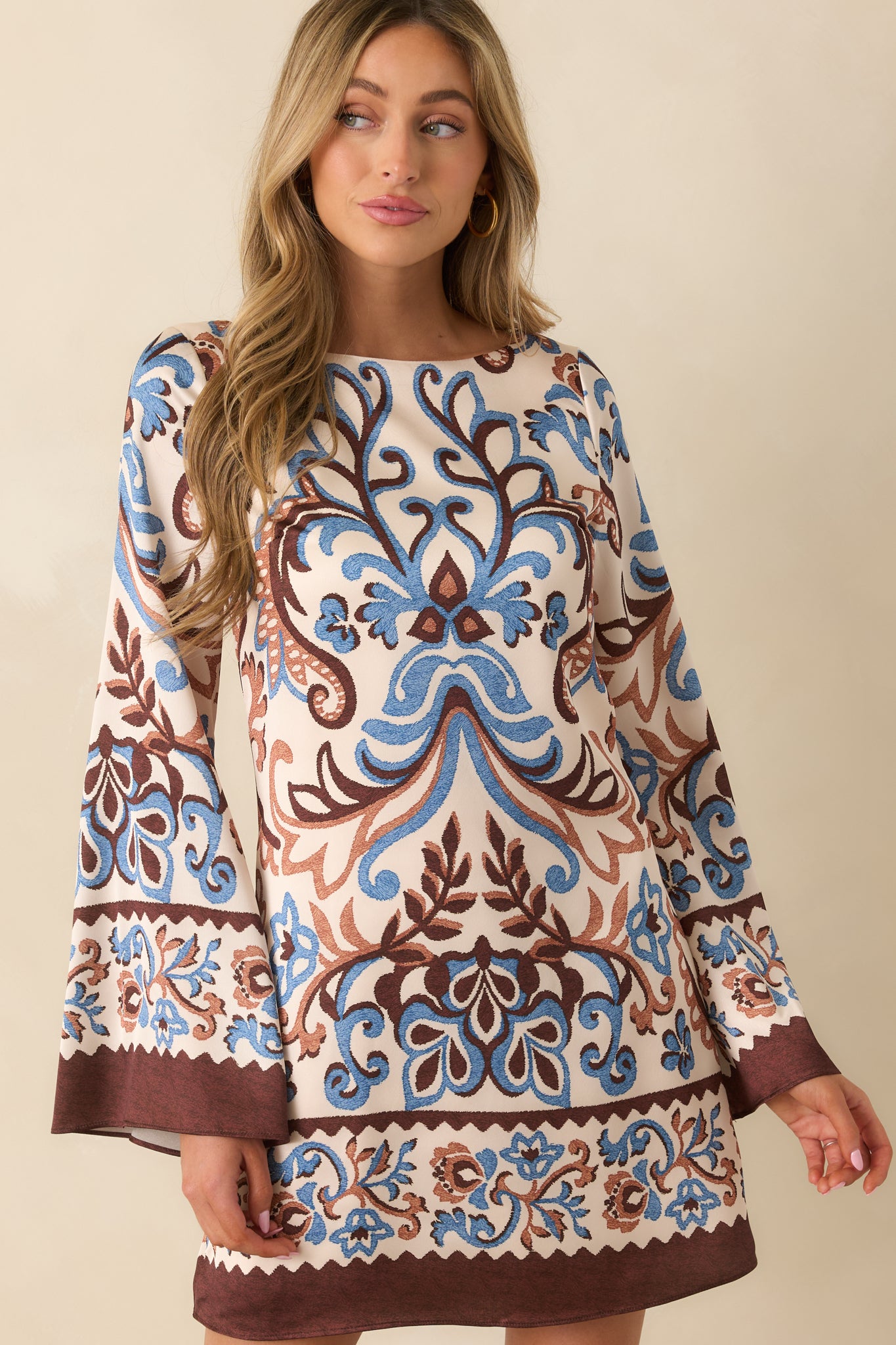 Cropped view focusing on the round neckline and upper paisley floral pattern.