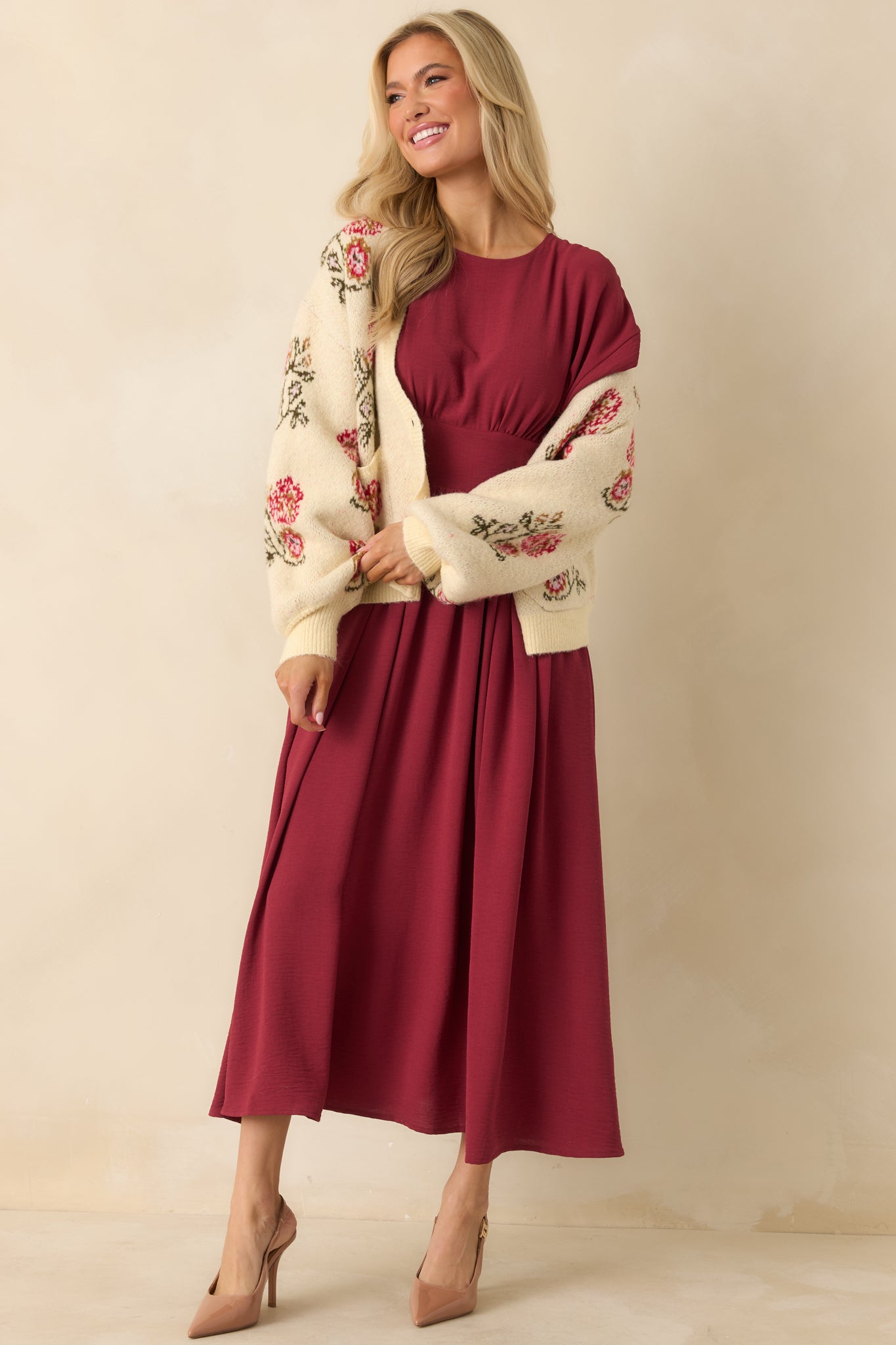 Burgundy dress with subtle sheen, fitted waist panel, and clean front silhouette.