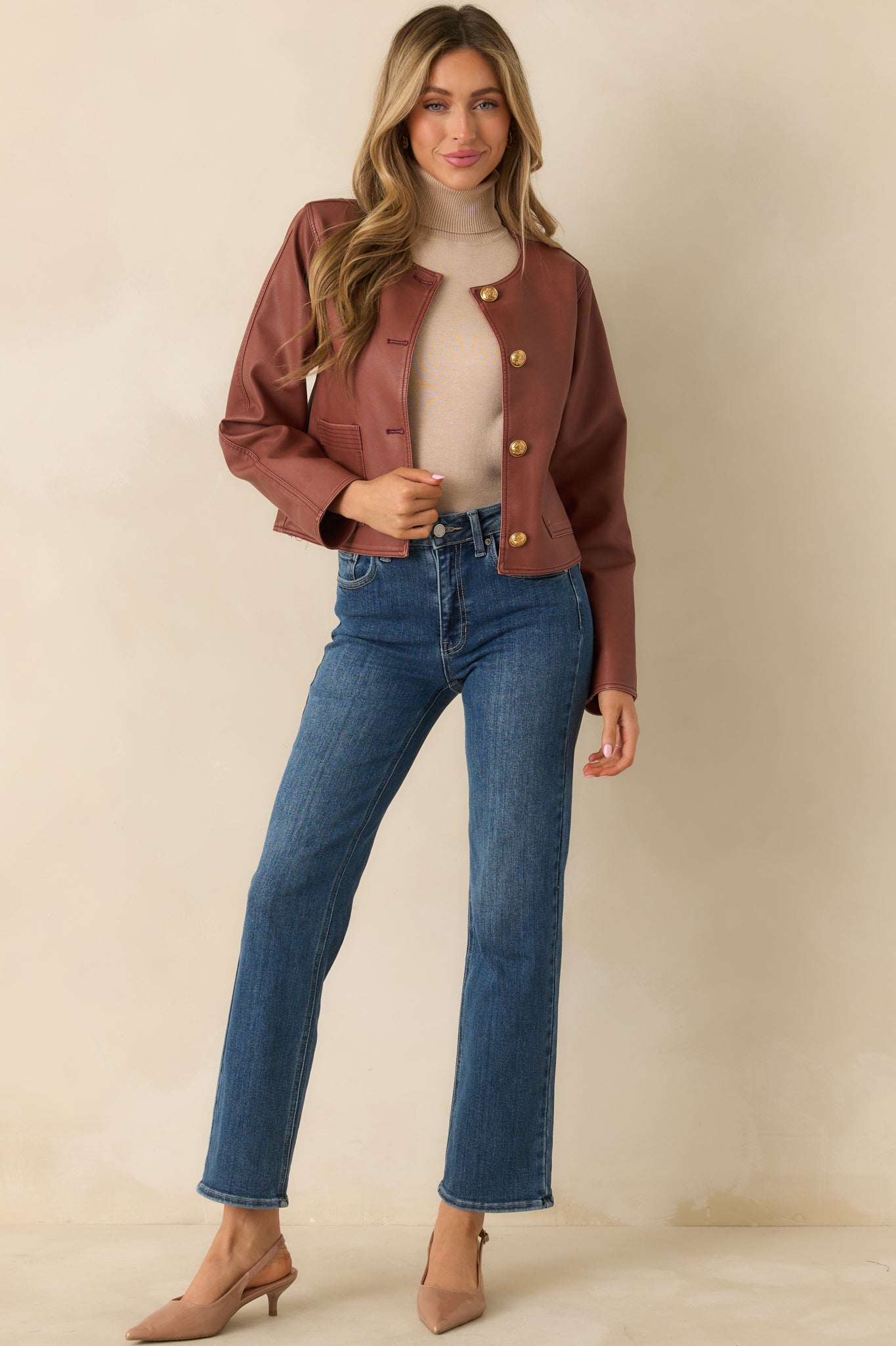 Cropped mauve jacket highlighting front button closure with embossed gold buttons.