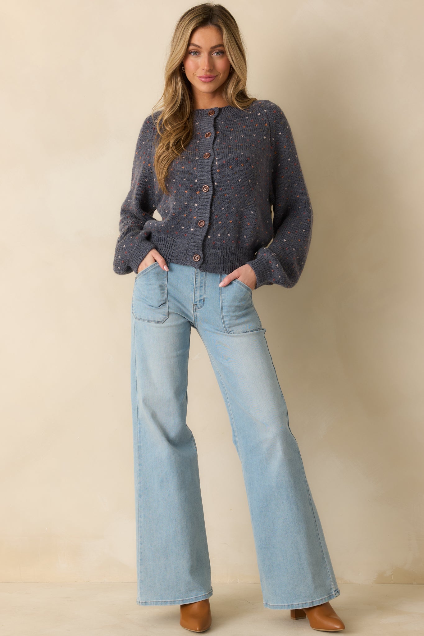 Soft wool blend cardigan featuring a relaxed fit and front button closure with heart accents.