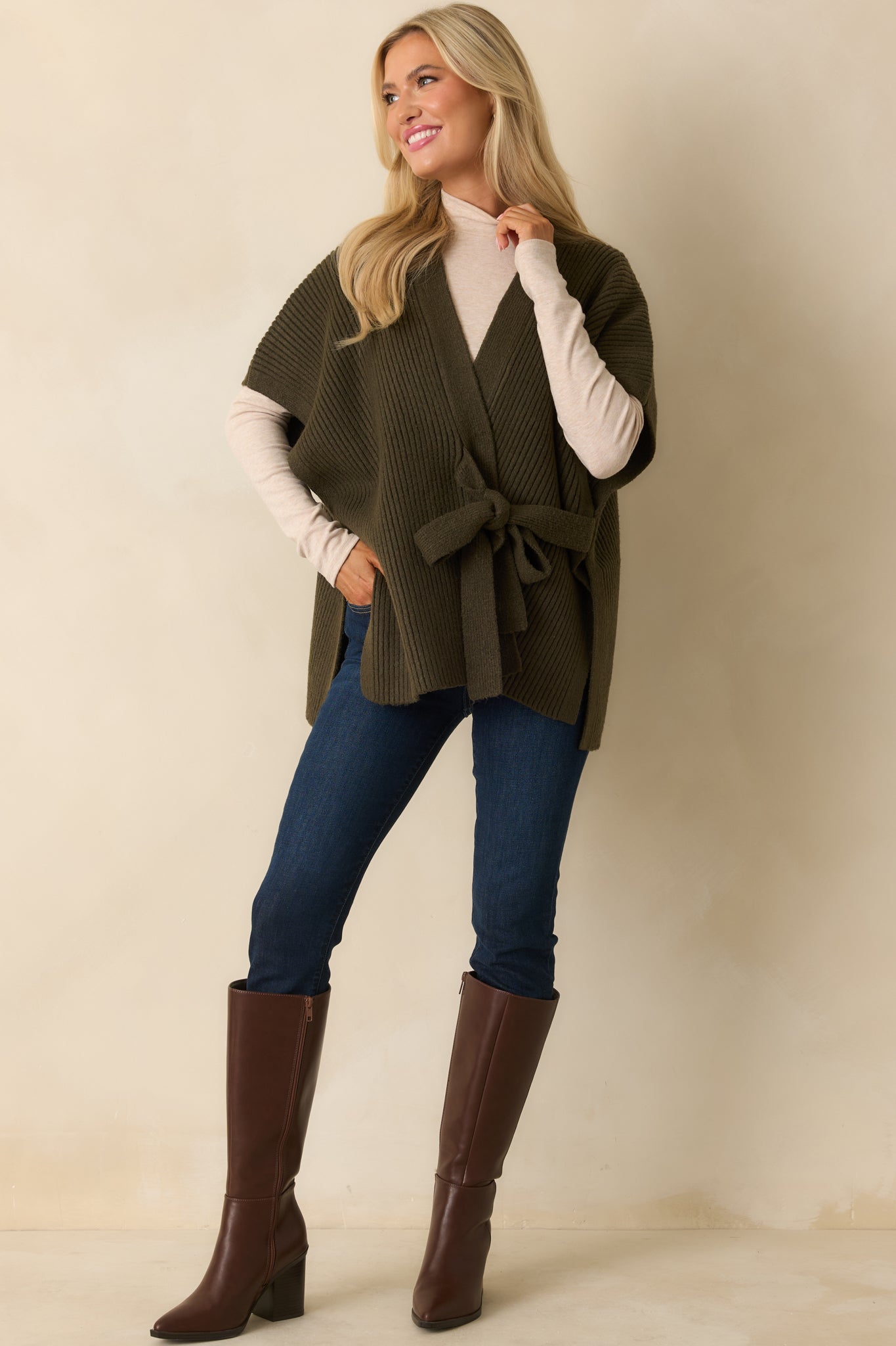 Olive green cardigan with short sleeves and belted waist showing loose, comfortable fit through the body.