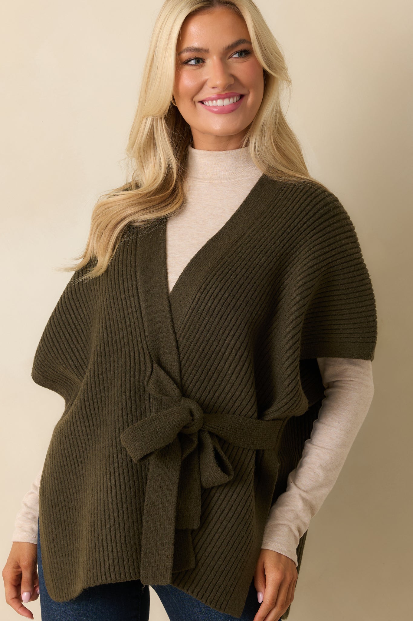 Cropped front view showing open neckline, self-tie belt, and ribbed texture of the cardigan.