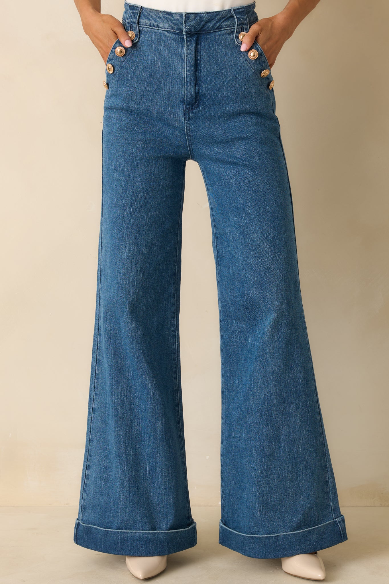 Cropped detail emphasizing the wide cuffed hems and full-length silhouette.