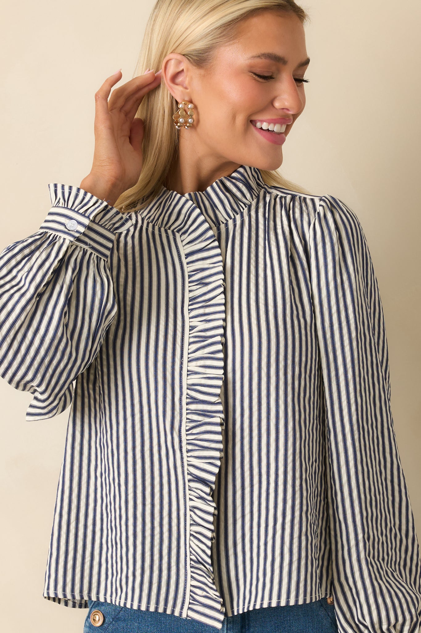 Cropped view emphasizing the ruffled front placket and soft woven seersucker finish.