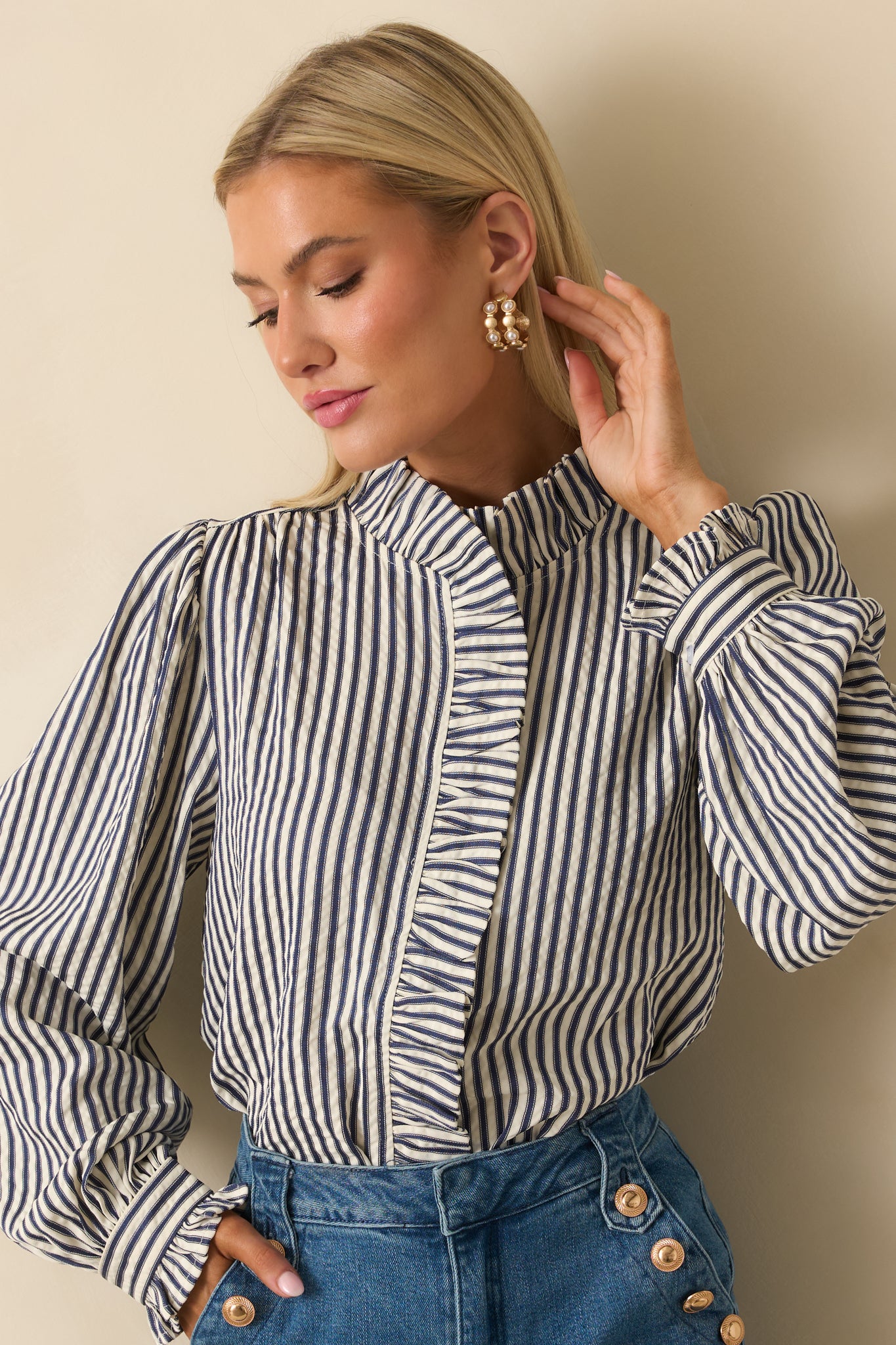 Cropped focus on the gathered cuffs and delicate button details on the sleeves.