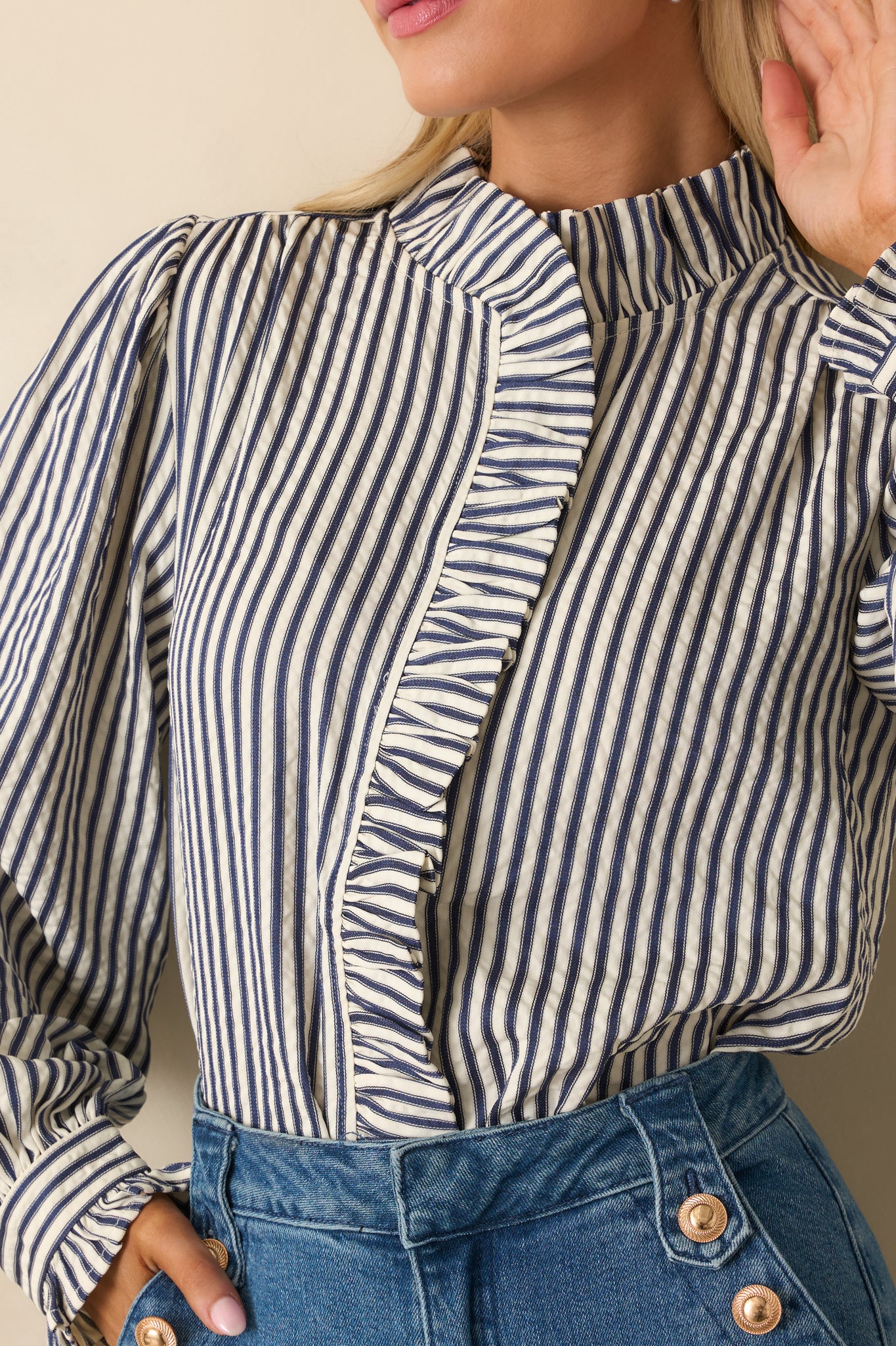 Close-up of the textured seersucker fabric with ruffled placket and button accents.