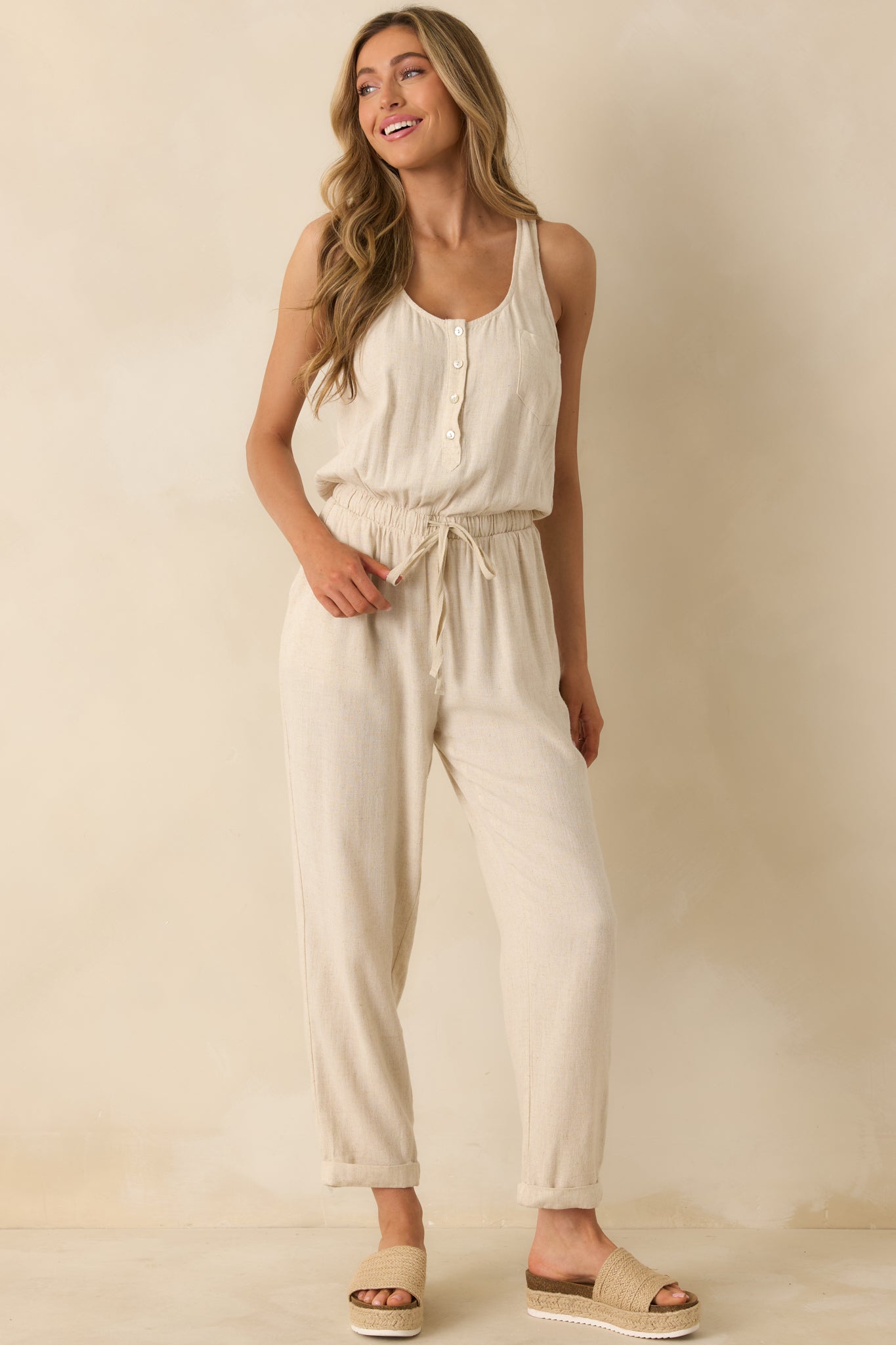 Front-facing jumpsuit with visible functional pockets and structured silhouette.