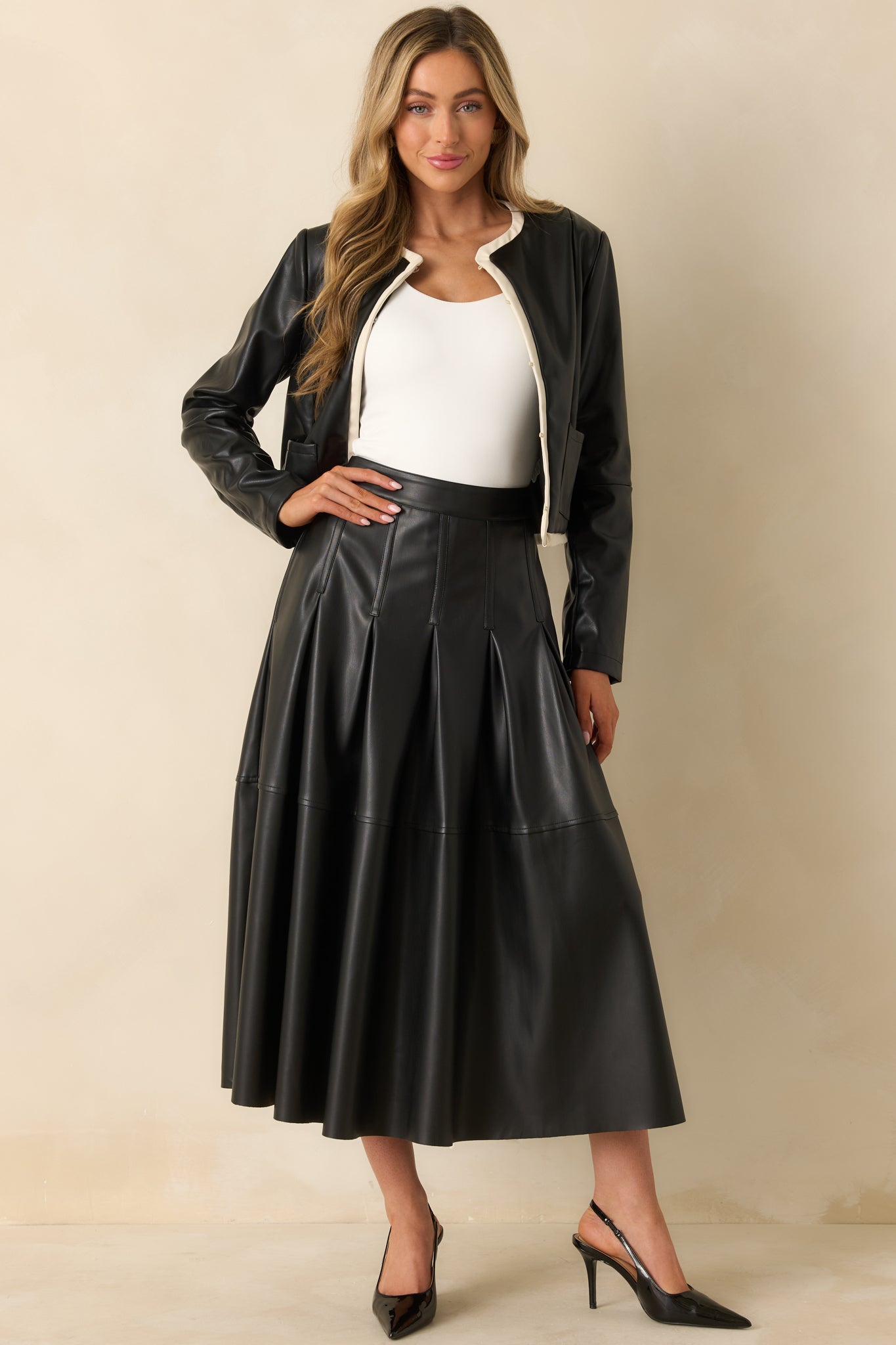Midi skirt showcasing a sleek silhouette with a polished finish and soft inner lining.