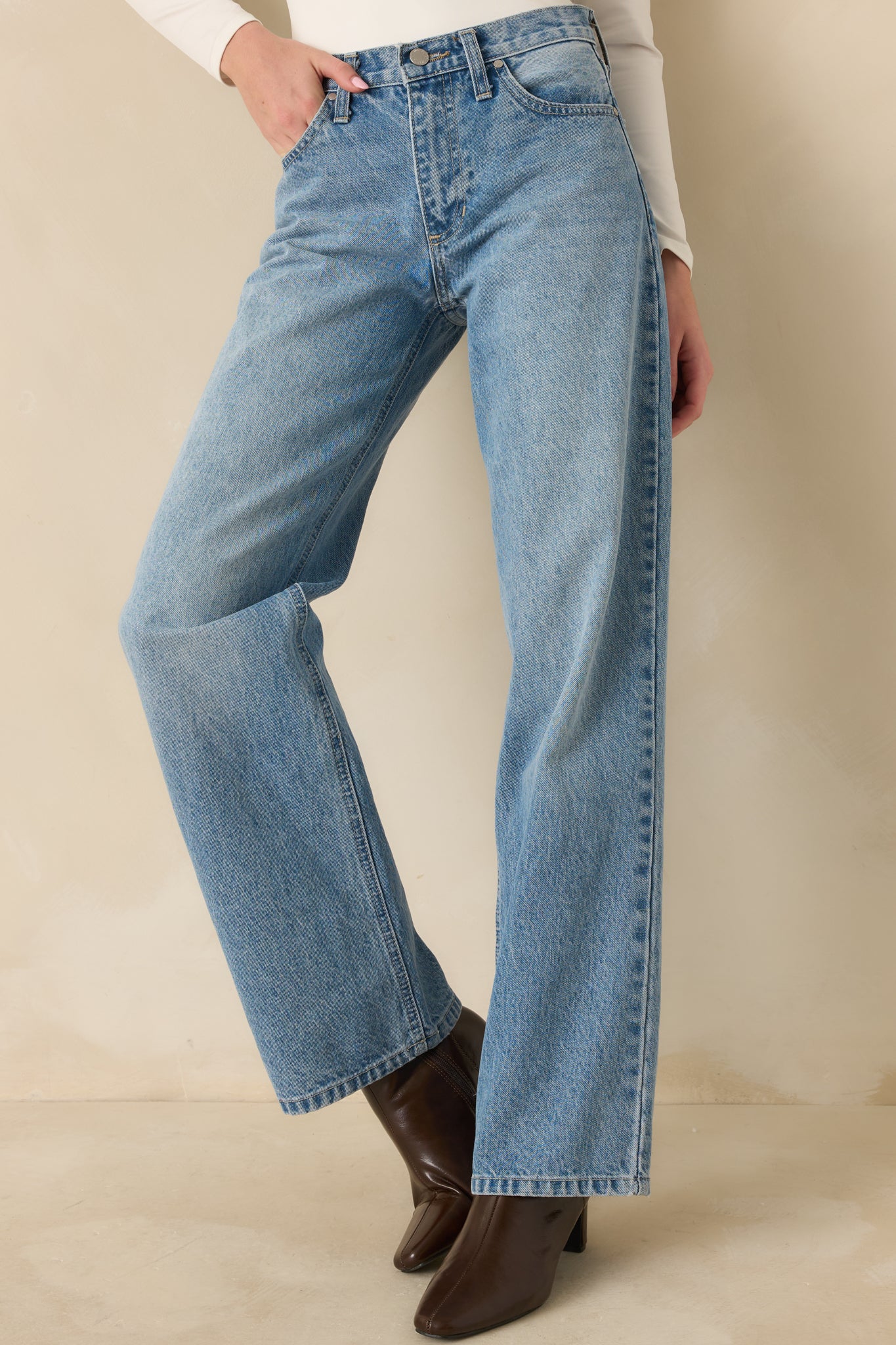Front-facing cropped view showing waistband, pockets, and clean jean lines.