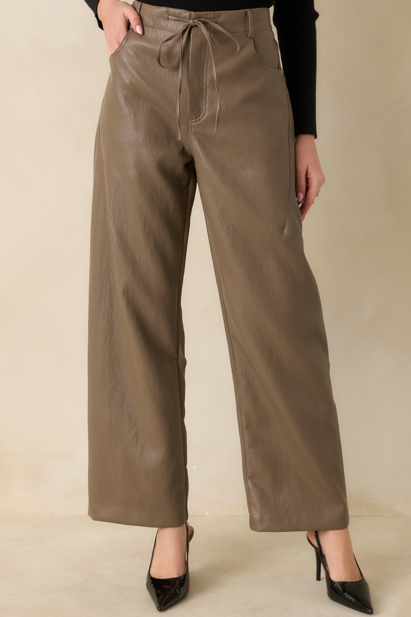 Cropped focus on the high-rise waistband with elastic gathering and front drawstring detail.