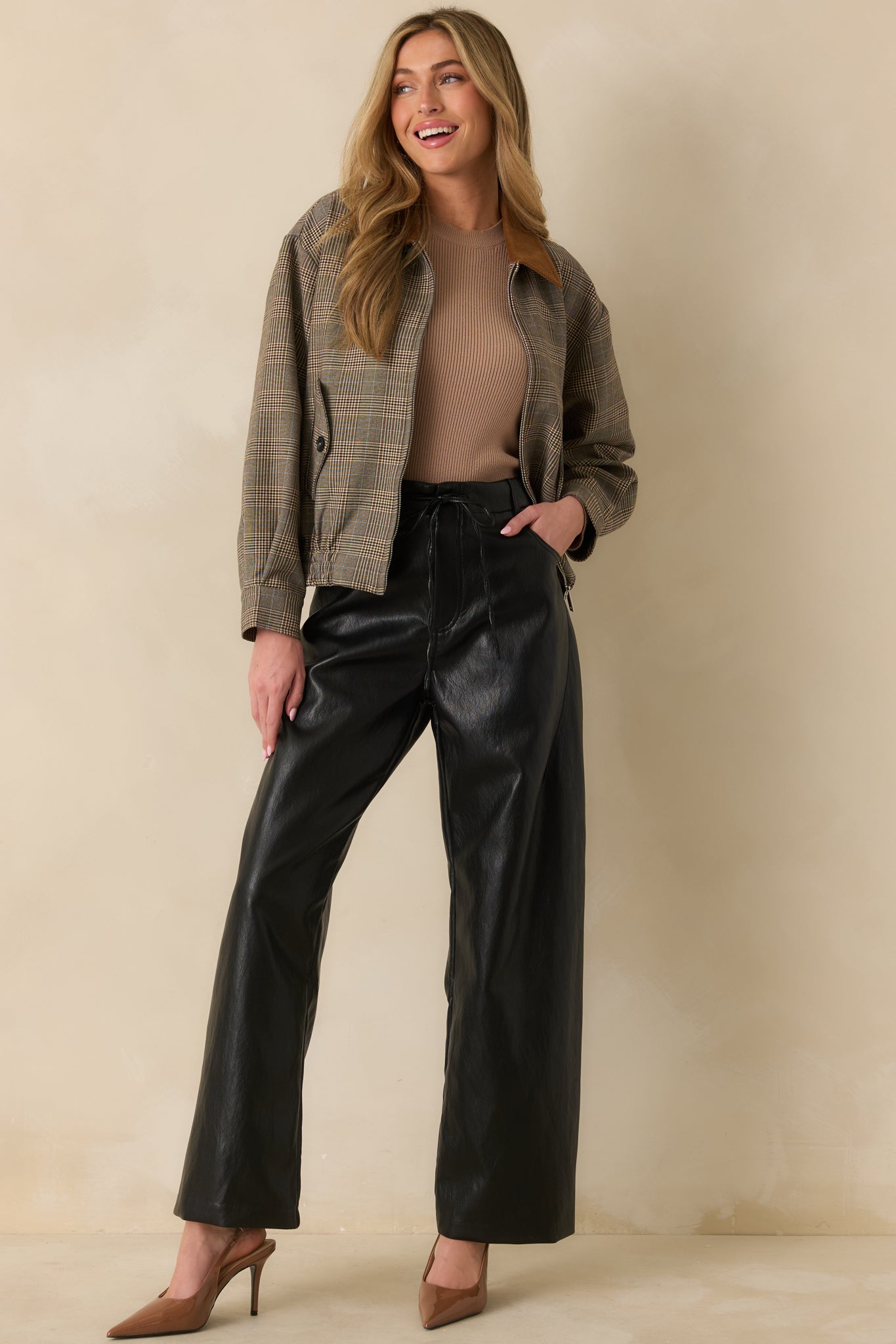 Full body shot highlighting button flap pockets, elastic hem, and woven plaid texture.