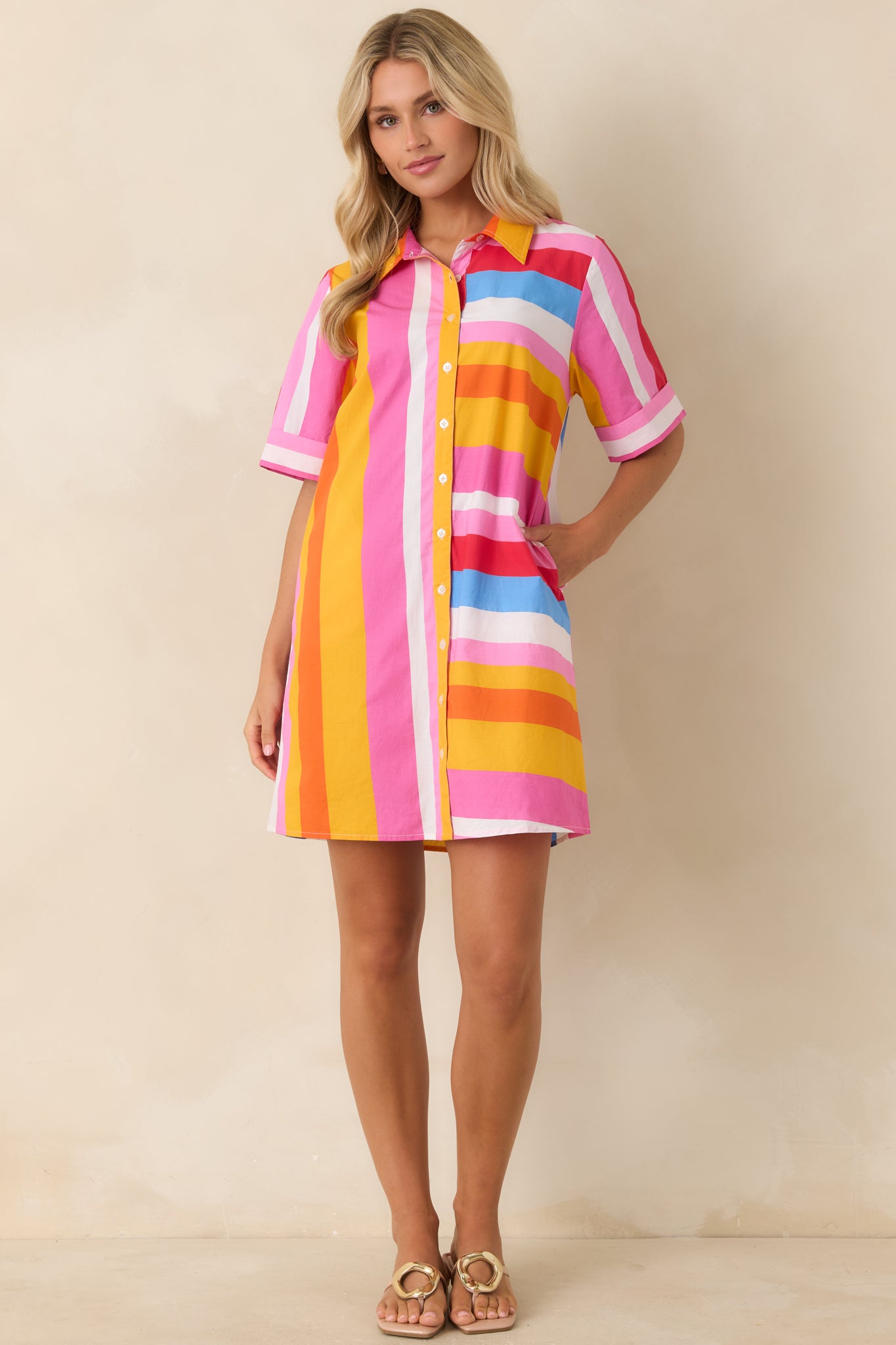 Casual cotton shirt dress with collared neckline, short sleeves, and vibrant multi stripe pattern.